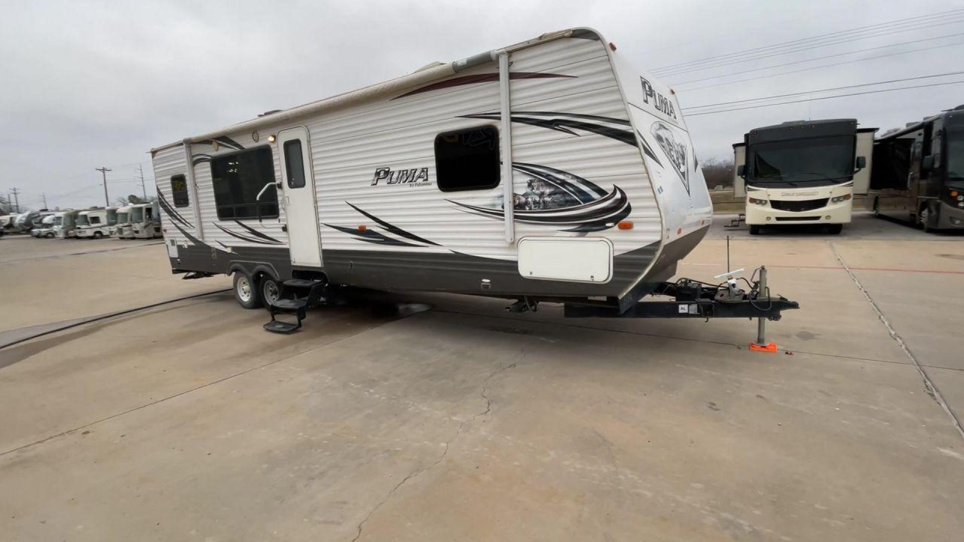 2014 WHITE PUMA 30RKSS (4X4TPUF23EP) , Length: 32.75 ft. | Dry Weight: 6,670 lbs. | Gross Weight: 9,827 lbs. | Slides: 1 transmission, located at 4319 N Main St, Cleburne, TX, 76033, (817) 678-5133, 32.385960, -97.391212 - Looking for a travel trailer that offers comfort, convenience, and style? Look no further than this 2014 PUMA 30RKSS available at RV Depot in Cleburne, TX. With its spacious interior, sleek white exterior, and rear living layout, this travel trailer is perfect for your next adventure. The PUMA 30RK - Photo#3