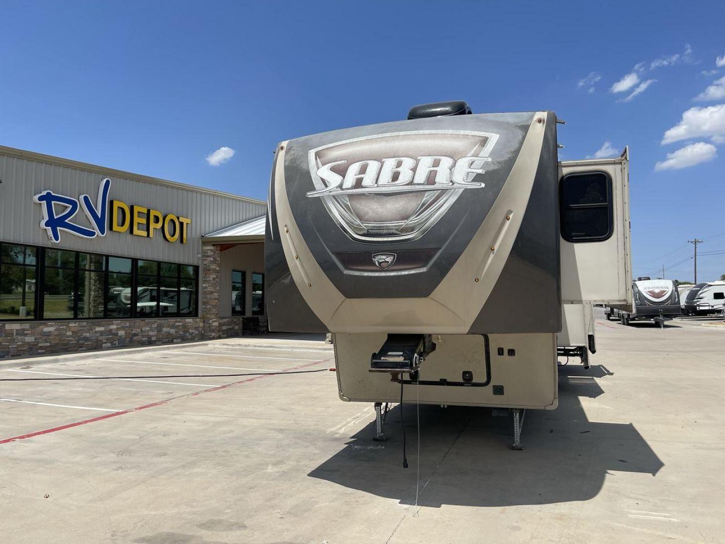 2014 TAN SABRE 34REQS-6 (4X4FSRK2XE3) , Length: 36 ft. | Dry Weight: 10,854 lbs. | Gross Weight: 13,704 lbs. | Slides: 4 transmission, located at 4319 N Main St, Cleburne, TX, 76033, (817) 678-5133, 32.385960, -97.391212 - This RV, which measures 36 feet in length and weighs 10,854 pounds dry, is designed to provide a luxurious and sumptuous living experience when traveling. With a gross weight of 13,704 pounds and four slides, including one in the bedroom, the 2014 Sabre 3REQS-6 Fifth Wheel will allow you plenty of s - Photo#0