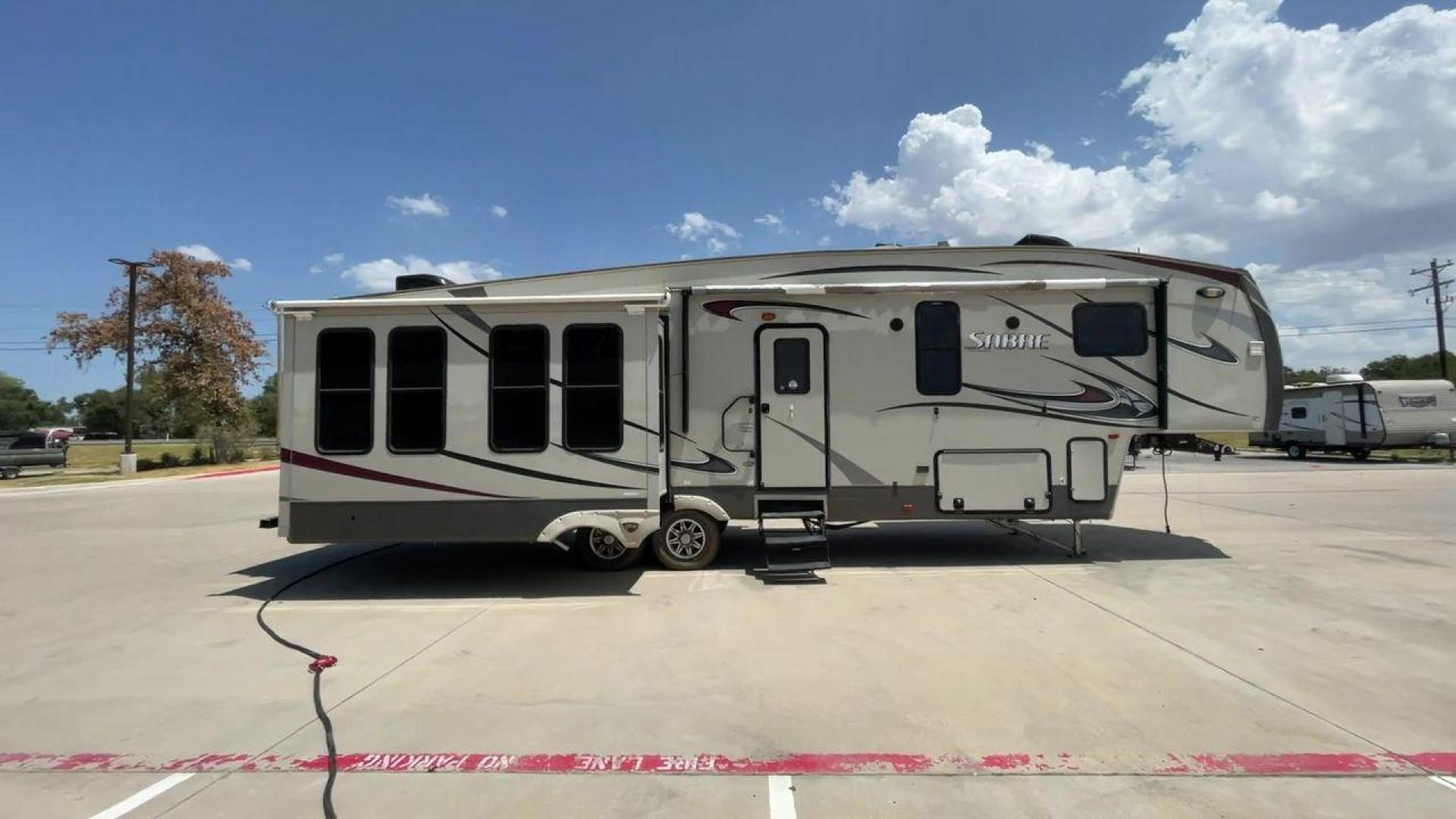 2014 TAN SABRE 34REQS-6 (4X4FSRK2XE3) , Length: 36 ft. | Dry Weight: 10,854 lbs. | Gross Weight: 13,704 lbs. | Slides: 4 transmission, located at 4319 N Main St, Cleburne, TX, 76033, (817) 678-5133, 32.385960, -97.391212 - This RV, which measures 36 feet in length and weighs 10,854 pounds dry, is designed to provide a luxurious and sumptuous living experience when traveling. With a gross weight of 13,704 pounds and four slides, including one in the bedroom, the 2014 Sabre 3REQS-6 Fifth Wheel will allow you plenty of s - Photo#2