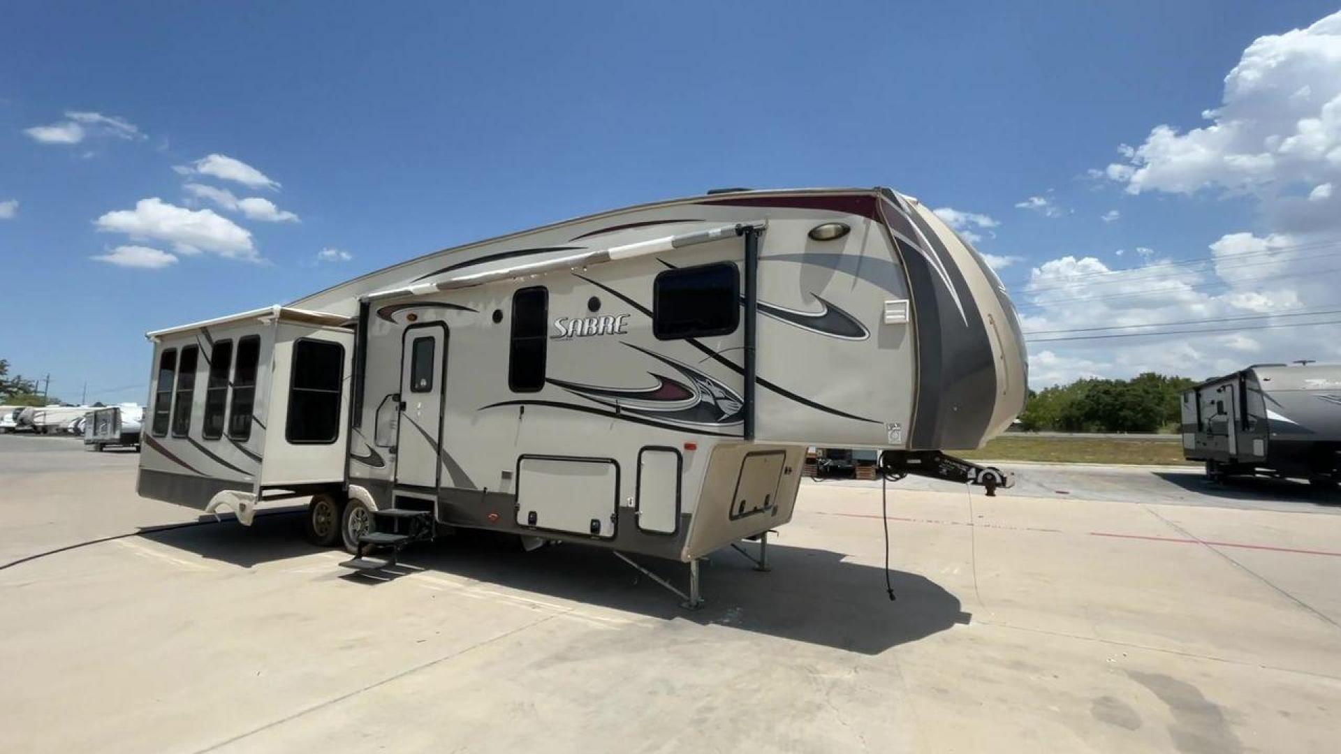 2014 TAN SABRE 34REQS-6 (4X4FSRK2XE3) , Length: 36 ft. | Dry Weight: 10,854 lbs. | Gross Weight: 13,704 lbs. | Slides: 4 transmission, located at 4319 N Main St, Cleburne, TX, 76033, (817) 678-5133, 32.385960, -97.391212 - This RV, which measures 36 feet in length and weighs 10,854 pounds dry, is designed to provide a luxurious and sumptuous living experience when traveling. With a gross weight of 13,704 pounds and four slides, including one in the bedroom, the 2014 Sabre 3REQS-6 Fifth Wheel will allow you plenty of s - Photo#3