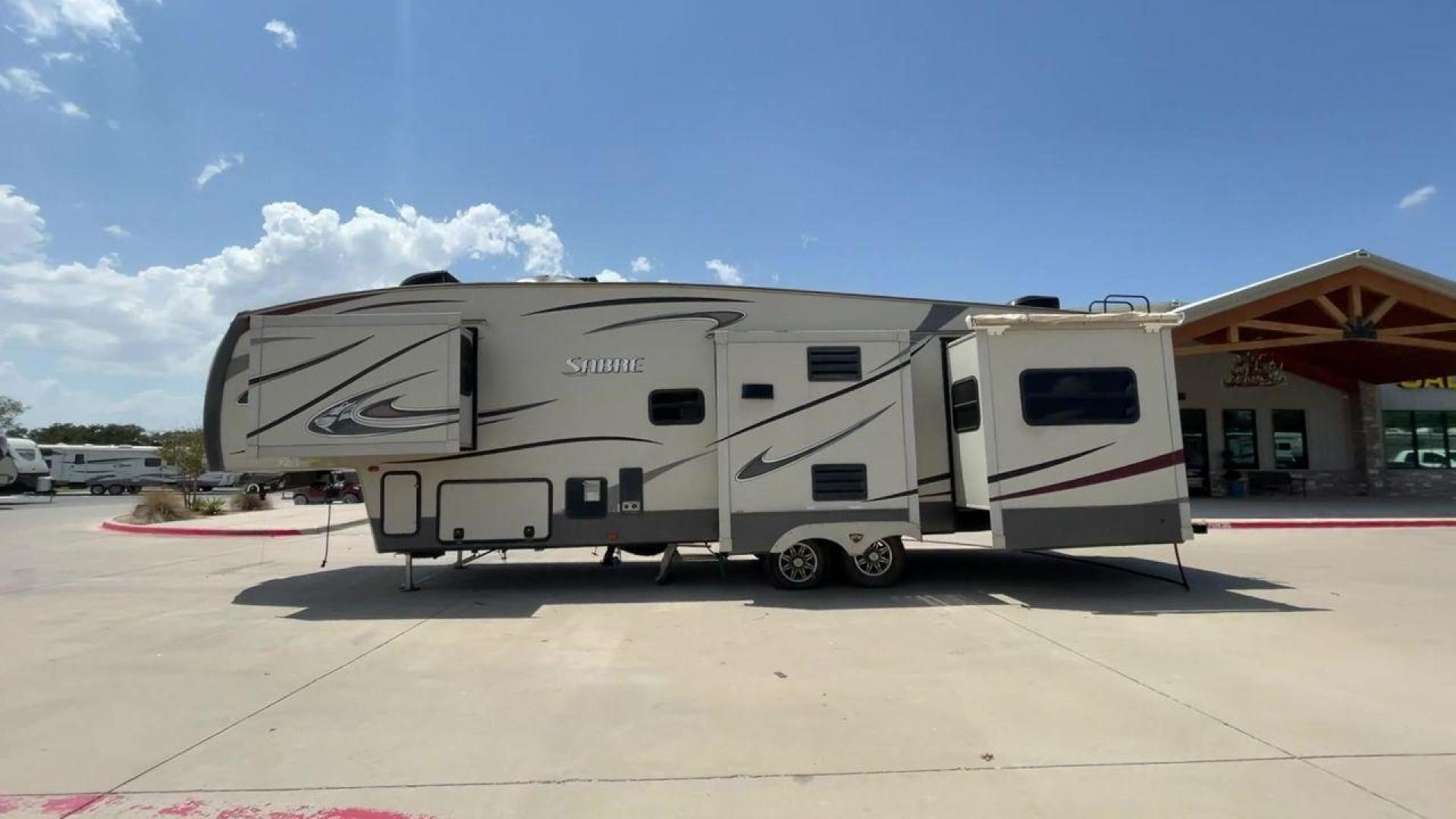 2014 TAN SABRE 34REQS-6 (4X4FSRK2XE3) , Length: 36 ft. | Dry Weight: 10,854 lbs. | Gross Weight: 13,704 lbs. | Slides: 4 transmission, located at 4319 N Main St, Cleburne, TX, 76033, (817) 678-5133, 32.385960, -97.391212 - This RV, which measures 36 feet in length and weighs 10,854 pounds dry, is designed to provide a luxurious and sumptuous living experience when traveling. With a gross weight of 13,704 pounds and four slides, including one in the bedroom, the 2014 Sabre 3REQS-6 Fifth Wheel will allow you plenty of s - Photo#6