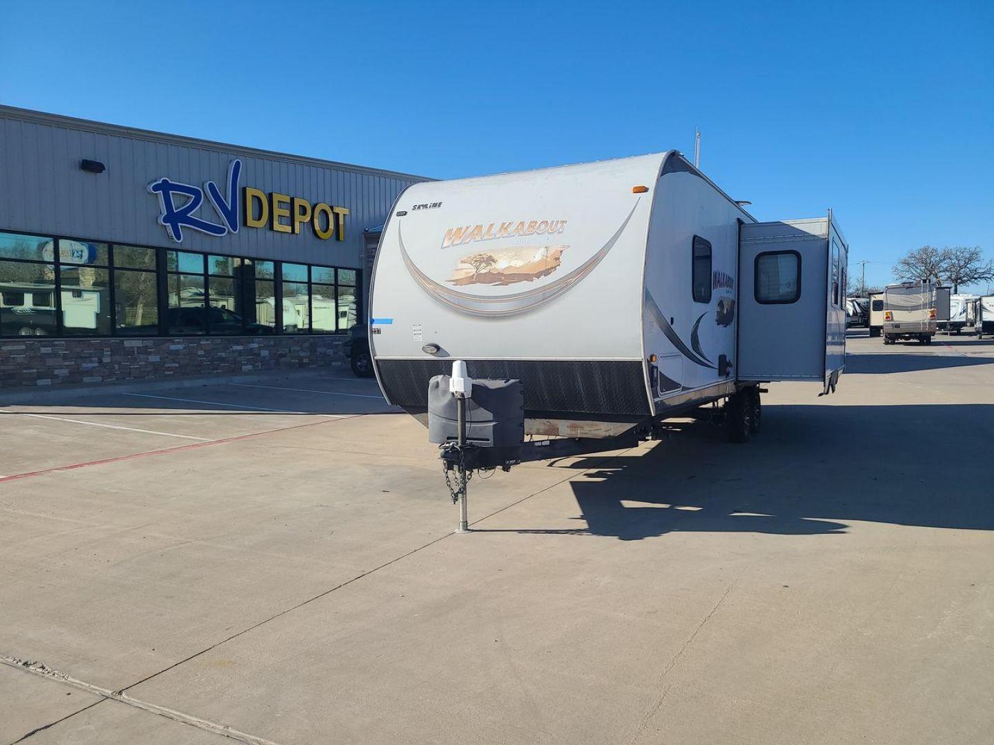 2014 TAN SKYLINE WALKABOUT 26SS - (1SE200M22EC) , Length: 29.25 ft. | Dry Weight: 5,350 lbs. | Slides: 1 transmission, located at 4319 N Main St, Cleburne, TX, 76033, (817) 678-5133, 32.385960, -97.391212 - In this elegantly constructed 2017 Forest River Sandpiper 3250IK Travel Trailer, enjoy comfortable and cozy camping. For those looking for a home away from home during their outdoor activities, this RV offers the ideal balance of comfort, design, and functionality. This trailer measures 29.5 ft in l - Photo#0