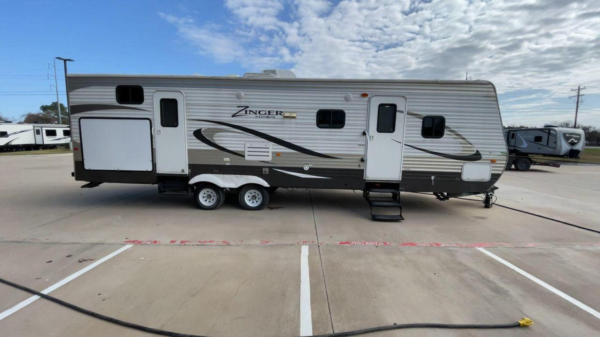 2014 TAN ZINGER 31SB (4V0TC3126EJ) , Length: 35.5 ft.| Dry Weight: 7,875 lbs. | Gross Weight: 9,671 lbs. | Slides: 2 transmission, located at 4319 N Main St, Cleburne, TX, 76033, (817) 678-5133, 32.385960, -97.391212 - This 2014 CrossRoads Zinger 31SB travel trailer measures 35.5 feet. It is a dual axle, steel wheel setup with electric drum brakes. Its dry weight is 7,875 lbs. Its payload is 1,796 lbs, hitch weight is 1,071 lbs and the GVWR 9.671 lbs. The fiberglass exterior is painted white and tan with dark tan - Photo#2