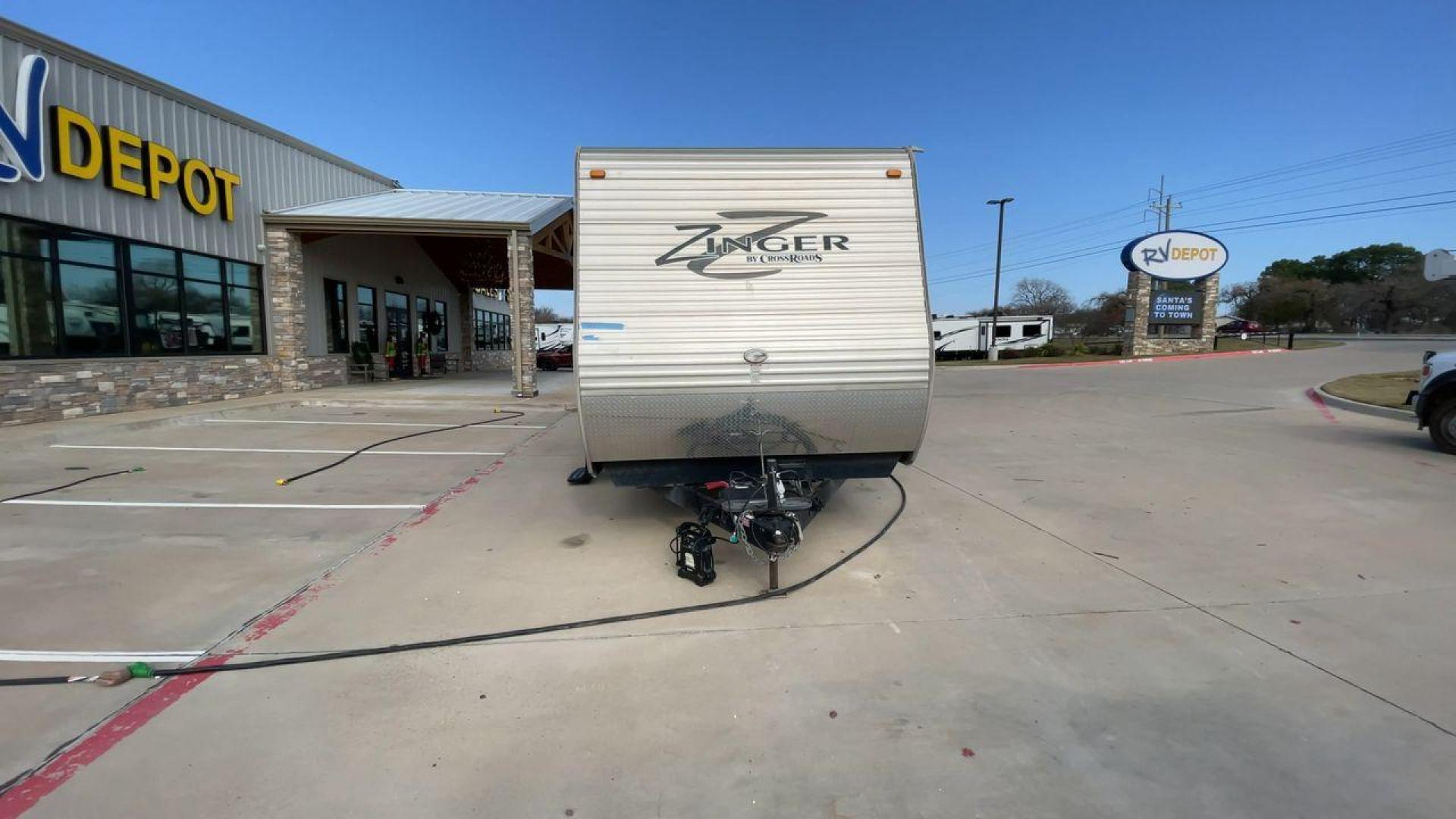 2014 TAN ZINGER 31SB (4V0TC3126EJ) , Length: 35.5 ft.| Dry Weight: 7,875 lbs. | Gross Weight: 9,671 lbs. | Slides: 2 transmission, located at 4319 N Main St, Cleburne, TX, 76033, (817) 678-5133, 32.385960, -97.391212 - This 2014 CrossRoads Zinger 31SB travel trailer measures 35.5 feet. It is a dual axle, steel wheel setup with electric drum brakes. Its dry weight is 7,875 lbs. Its payload is 1,796 lbs, hitch weight is 1,071 lbs and the GVWR 9.671 lbs. The fiberglass exterior is painted white and tan with dark tan - Photo#4