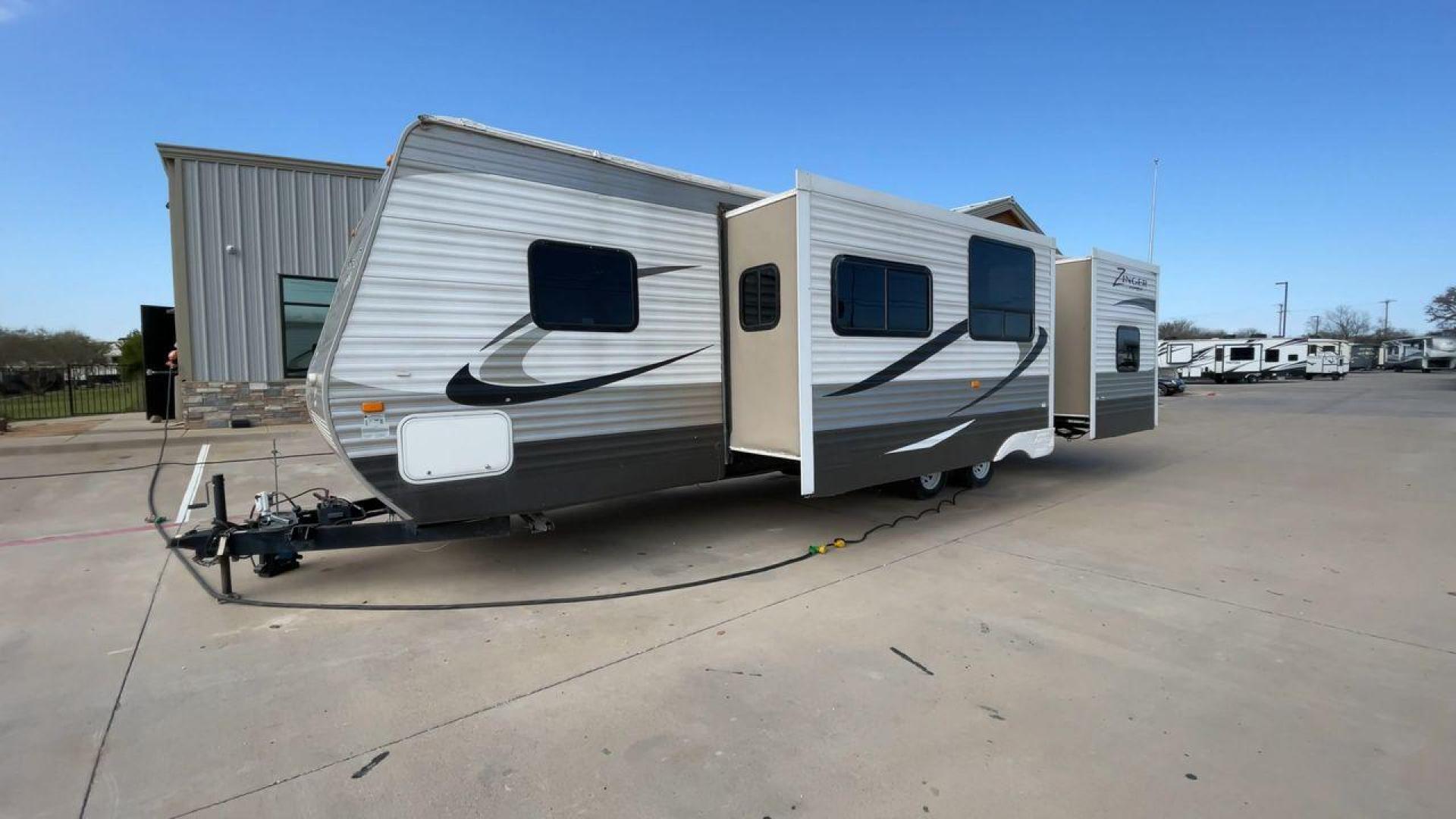 2014 TAN ZINGER 31SB (4V0TC3126EJ) , Length: 35.5 ft.| Dry Weight: 7,875 lbs. | Gross Weight: 9,671 lbs. | Slides: 2 transmission, located at 4319 N Main St, Cleburne, TX, 76033, (817) 678-5133, 32.385960, -97.391212 - This 2014 CrossRoads Zinger 31SB travel trailer measures 35.5 feet. It is a dual axle, steel wheel setup with electric drum brakes. Its dry weight is 7,875 lbs. Its payload is 1,796 lbs, hitch weight is 1,071 lbs and the GVWR 9.671 lbs. The fiberglass exterior is painted white and tan with dark tan - Photo#5