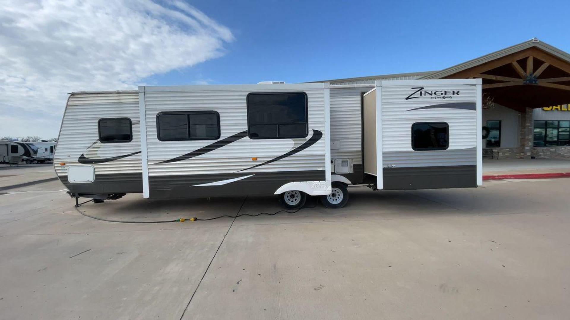 2014 TAN ZINGER 31SB (4V0TC3126EJ) , Length: 35.5 ft.| Dry Weight: 7,875 lbs. | Gross Weight: 9,671 lbs. | Slides: 2 transmission, located at 4319 N Main St, Cleburne, TX, 76033, (817) 678-5133, 32.385960, -97.391212 - This 2014 CrossRoads Zinger 31SB travel trailer measures 35.5 feet. It is a dual axle, steel wheel setup with electric drum brakes. Its dry weight is 7,875 lbs. Its payload is 1,796 lbs, hitch weight is 1,071 lbs and the GVWR 9.671 lbs. The fiberglass exterior is painted white and tan with dark tan - Photo#6