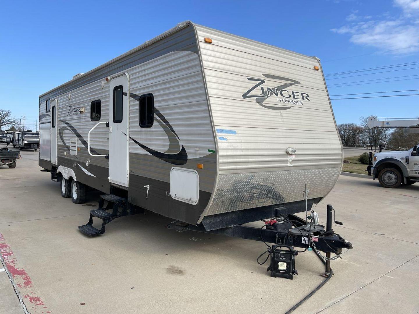 2014 TAN ZINGER 31SB (4V0TC3126EJ) , Length: 35.5 ft.| Dry Weight: 7,875 lbs. | Gross Weight: 9,671 lbs. | Slides: 2 transmission, located at 4319 N Main St, Cleburne, TX, 76033, (817) 678-5133, 32.385960, -97.391212 - This 2014 CrossRoads Zinger 31SB travel trailer measures 35.5 feet. It is a dual axle, steel wheel setup with electric drum brakes. Its dry weight is 7,875 lbs. Its payload is 1,796 lbs, hitch weight is 1,071 lbs and the GVWR 9.671 lbs. The fiberglass exterior is painted white and tan with dark tan - Photo#22