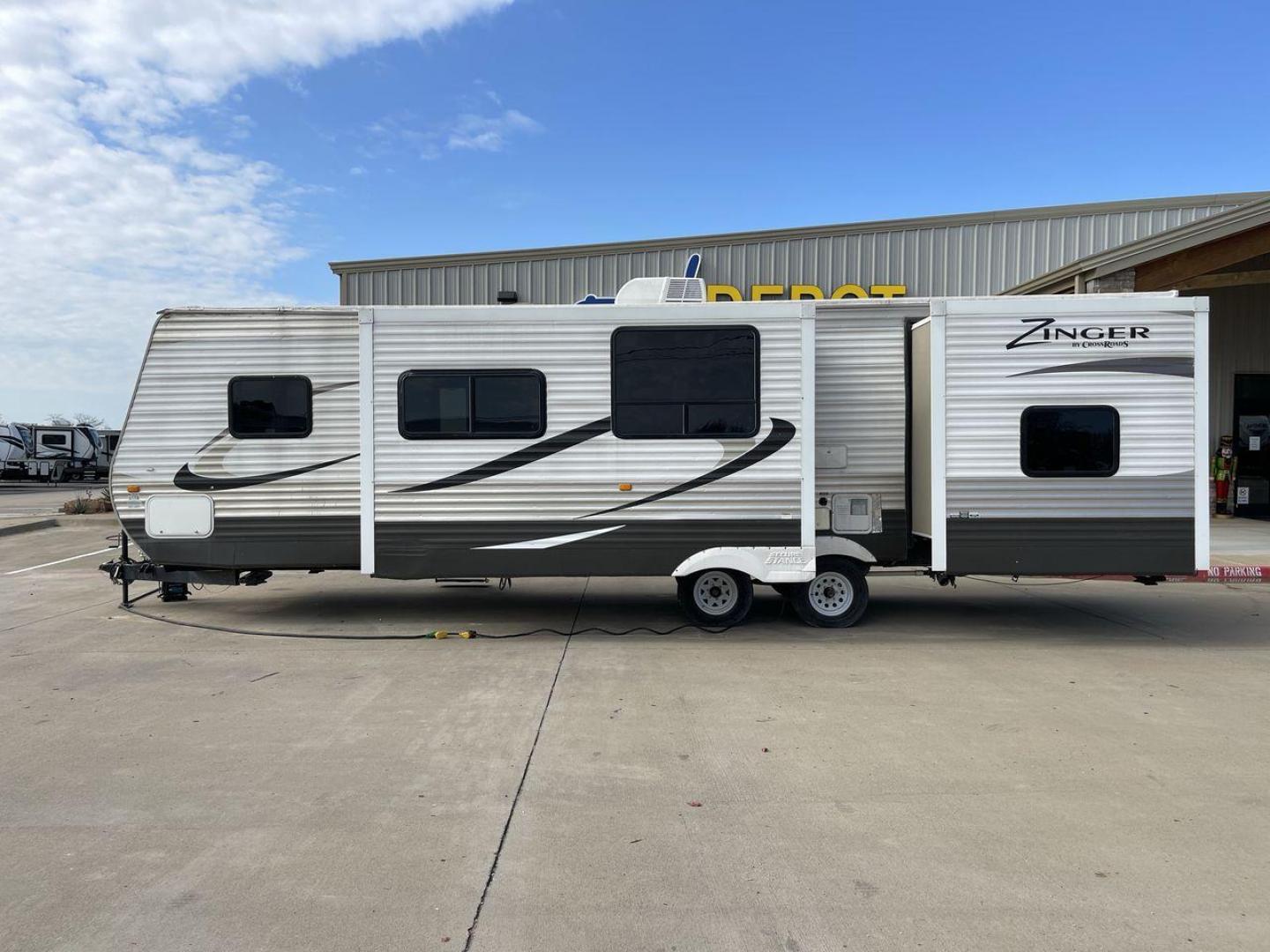 2014 TAN ZINGER 31SB (4V0TC3126EJ) , Length: 35.5 ft.| Dry Weight: 7,875 lbs. | Gross Weight: 9,671 lbs. | Slides: 2 transmission, located at 4319 N Main St, Cleburne, TX, 76033, (817) 678-5133, 32.385960, -97.391212 - This 2014 CrossRoads Zinger 31SB travel trailer measures 35.5 feet. It is a dual axle, steel wheel setup with electric drum brakes. Its dry weight is 7,875 lbs. Its payload is 1,796 lbs, hitch weight is 1,071 lbs and the GVWR 9.671 lbs. The fiberglass exterior is painted white and tan with dark tan - Photo#23