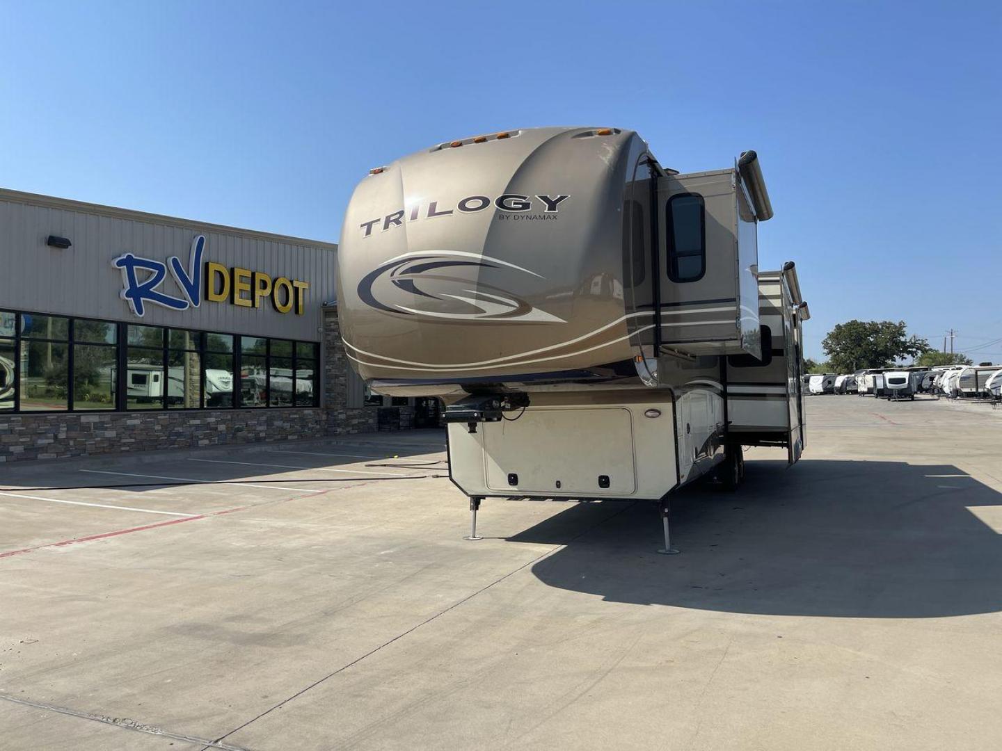 2015 TAN DYNAMAX TRILOGY 37BH - (5ZT3TL2B8FC) , Length: 42 ft. | Dry Weight: 15,638 lbs. | Gross Weight: 18,550 lbs. | Slides: 5 transmission, located at 4319 N Main St, Cleburne, TX, 76033, (817) 678-5133, 32.385960, -97.391212 - Photo#0