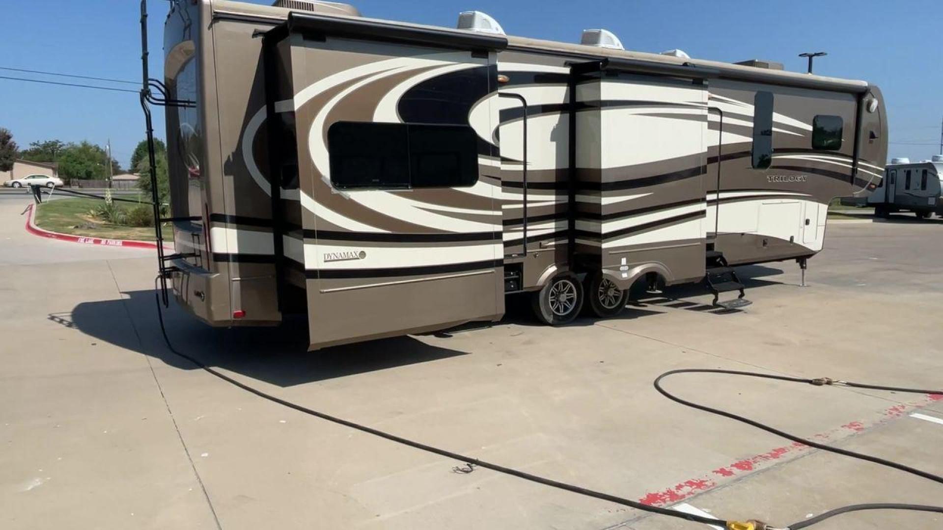 2015 TAN DYNAMAX TRILOGY 37BH - (5ZT3TL2B8FC) , Length: 42 ft. | Dry Weight: 15,638 lbs. | Gross Weight: 18,550 lbs. | Slides: 5 transmission, located at 4319 N Main St, Cleburne, TX, 76033, (817) 678-5133, 32.385960, -97.391212 - Photo#1