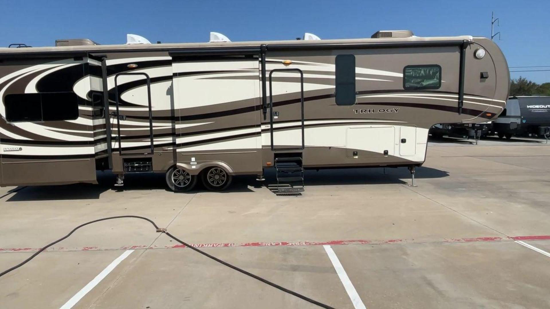 2015 TAN DYNAMAX TRILOGY 37BH - (5ZT3TL2B8FC) , Length: 42 ft. | Dry Weight: 15,638 lbs. | Gross Weight: 18,550 lbs. | Slides: 5 transmission, located at 4319 N Main St, Cleburne, TX, 76033, (817) 678-5133, 32.385960, -97.391212 - Photo#2