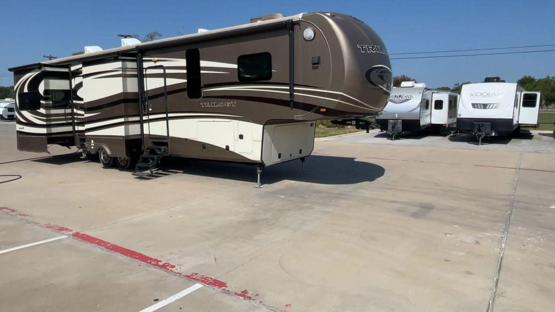 2015 TAN DYNAMAX TRILOGY 37BH - (5ZT3TL2B8FC) , Length: 42 ft. | Dry Weight: 15,638 lbs. | Gross Weight: 18,550 lbs. | Slides: 5 transmission, located at 4319 N Main St, Cleburne, TX, 76033, (817) 678-5133, 32.385960, -97.391212 - Photo#3