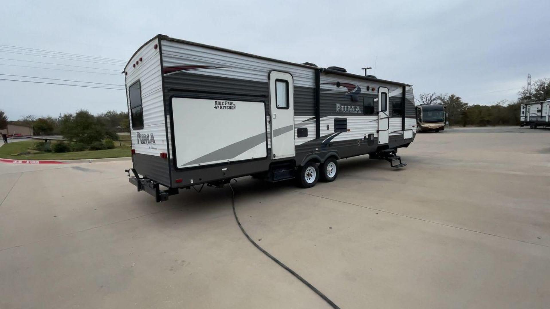 2015 FOREST RIVER PUMA 31BHSS (4X4TPUG21FP) , Length: 35.33 ft. | Dry Weight: 7,702 lbs. | Gross Weight: 10,236 lbs. | Slides: 2 transmission, located at 4319 N Main St, Cleburne, TX, 76033, (817) 678-5133, 32.385960, -97.391212 - The 2015 Forest River Puma 31BH RV features a classic and durable exterior design. The body of the RV is a combination of gray, white, and black with accents of maroon, which gives it a rugged yet stylish look. The sides have aluminum panels with a ribbed texture, which not only adds to the aestheti - Photo#1