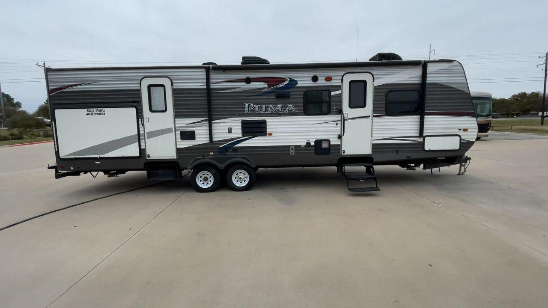 2015 FOREST RIVER PUMA 31BHSS (4X4TPUG21FP) , Length: 35.33 ft. | Dry Weight: 7,702 lbs. | Gross Weight: 10,236 lbs. | Slides: 2 transmission, located at 4319 N Main St, Cleburne, TX, 76033, (817) 678-5133, 32.385960, -97.391212 - The 2015 Forest River Puma 31BH RV features a classic and durable exterior design. The body of the RV is a combination of gray, white, and black with accents of maroon, which gives it a rugged yet stylish look. The sides have aluminum panels with a ribbed texture, which not only adds to the aestheti - Photo#2