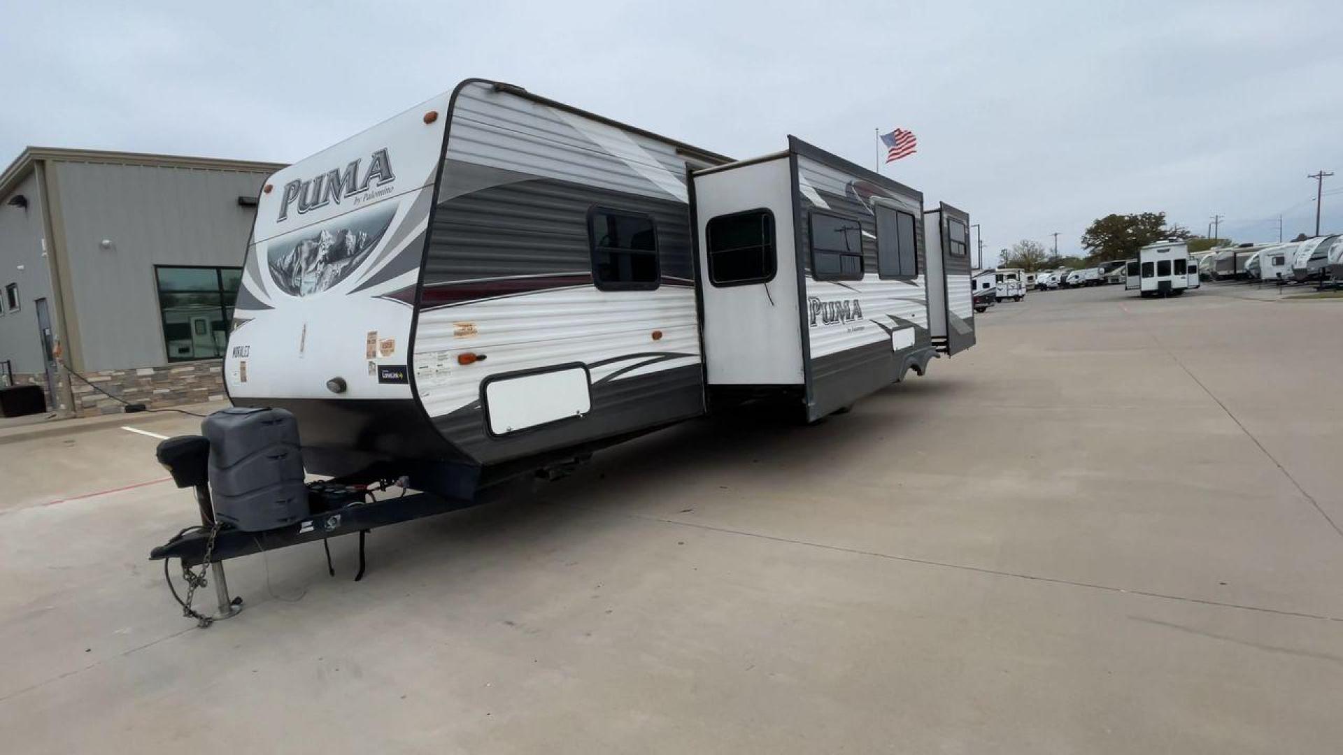 2015 FOREST RIVER PUMA 31BHSS (4X4TPUG21FP) , Length: 35.33 ft. | Dry Weight: 7,702 lbs. | Gross Weight: 10,236 lbs. | Slides: 2 transmission, located at 4319 N Main St, Cleburne, TX, 76033, (817) 678-5133, 32.385960, -97.391212 - The 2015 Forest River Puma 31BH RV features a classic and durable exterior design. The body of the RV is a combination of gray, white, and black with accents of maroon, which gives it a rugged yet stylish look. The sides have aluminum panels with a ribbed texture, which not only adds to the aestheti - Photo#5