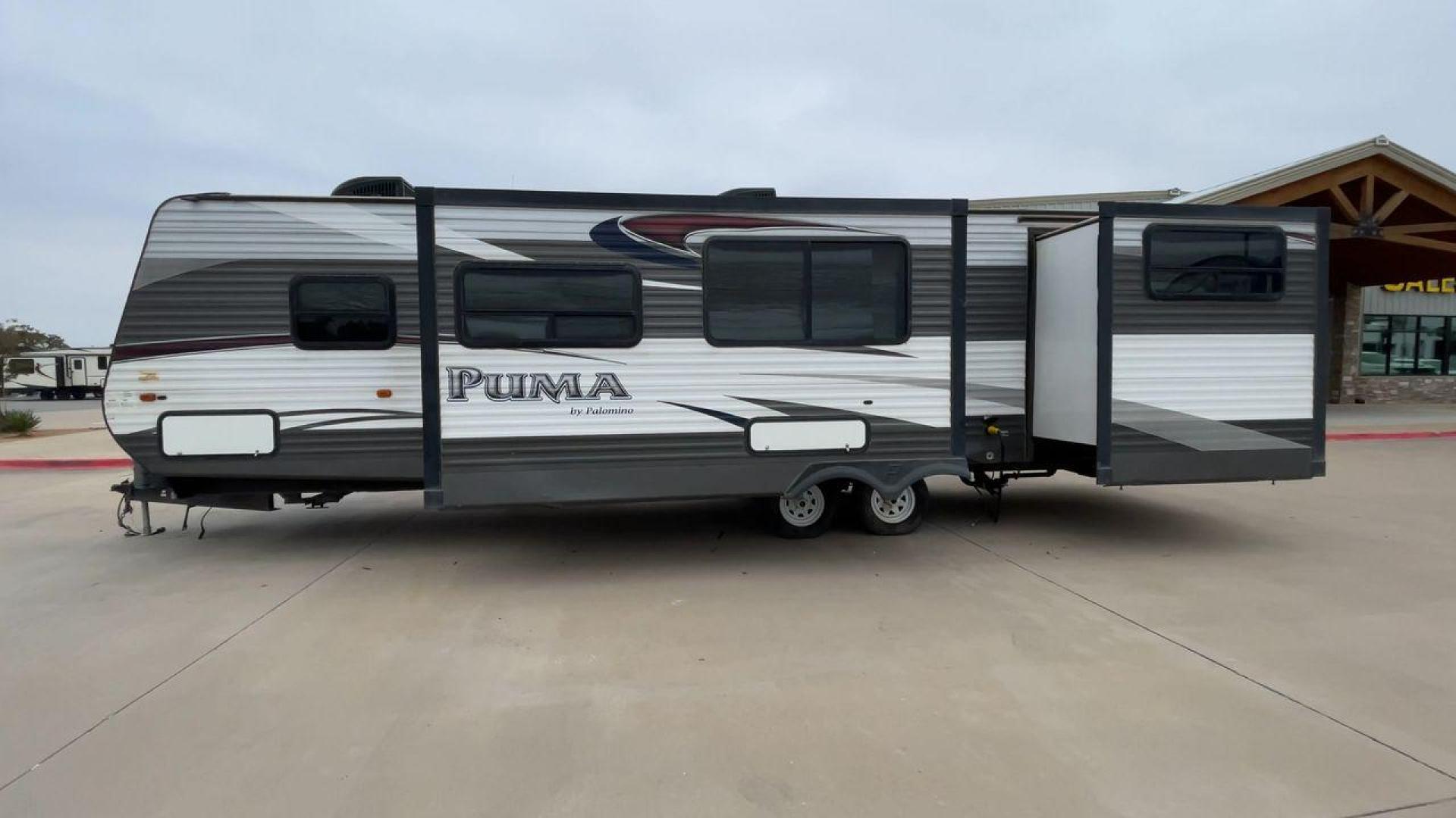 2015 FOREST RIVER PUMA 31BHSS (4X4TPUG21FP) , Length: 35.33 ft. | Dry Weight: 7,702 lbs. | Gross Weight: 10,236 lbs. | Slides: 2 transmission, located at 4319 N Main St, Cleburne, TX, 76033, (817) 678-5133, 32.385960, -97.391212 - The 2015 Forest River Puma 31BH RV features a classic and durable exterior design. The body of the RV is a combination of gray, white, and black with accents of maroon, which gives it a rugged yet stylish look. The sides have aluminum panels with a ribbed texture, which not only adds to the aestheti - Photo#6