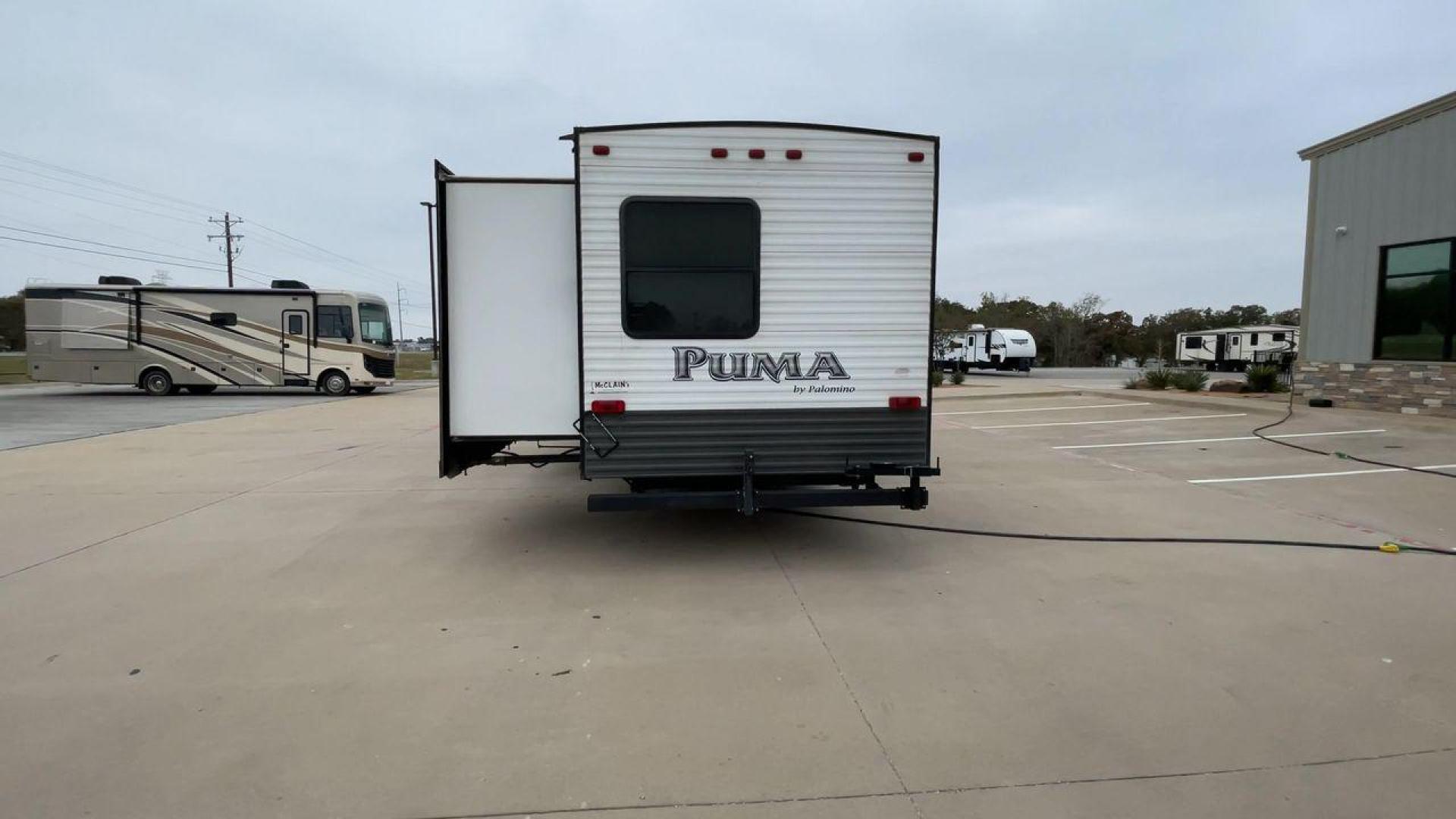 2015 FOREST RIVER PUMA 31BHSS (4X4TPUG21FP) , Length: 35.33 ft. | Dry Weight: 7,702 lbs. | Gross Weight: 10,236 lbs. | Slides: 2 transmission, located at 4319 N Main St, Cleburne, TX, 76033, (817) 678-5133, 32.385960, -97.391212 - The 2015 Forest River Puma 31BH RV features a classic and durable exterior design. The body of the RV is a combination of gray, white, and black with accents of maroon, which gives it a rugged yet stylish look. The sides have aluminum panels with a ribbed texture, which not only adds to the aestheti - Photo#8