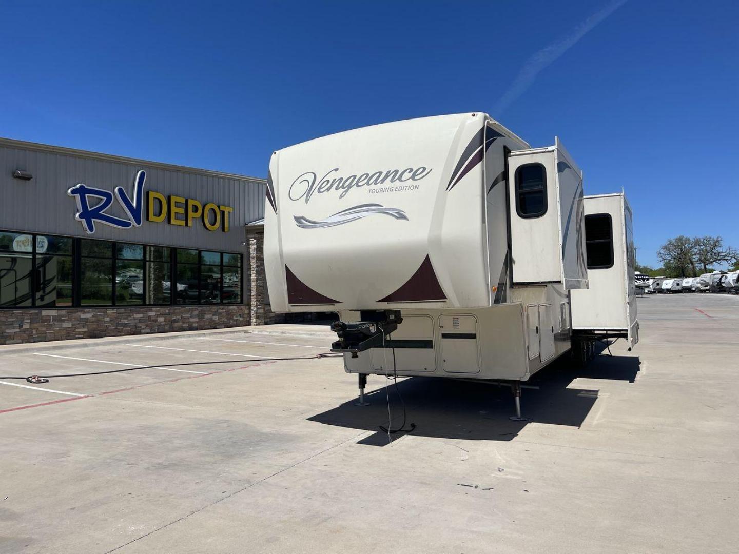 2015 TAN FOREST RIVER VENGEANCE - (4X4FVGR30FR) , Length: 42.83 ft. | Dry Weight: 14,270 lbs. | Gross Weight: 17,500 lbs. | Slides: 3 transmission, located at 4319 N Main St, Cleburne, TX, 76033, (817) 678-5133, 32.385960, -97.391212 - Designed to provide comfort and adventure to your travels, the 2015 Forest River Vengeance 39B12 is a tough and adaptable fifth wheel toy hauler. With a dry weight of 14,270 pounds and a length of a little over 42 feet, this model offers plenty of room for your belongings while still being towable - Photo#0