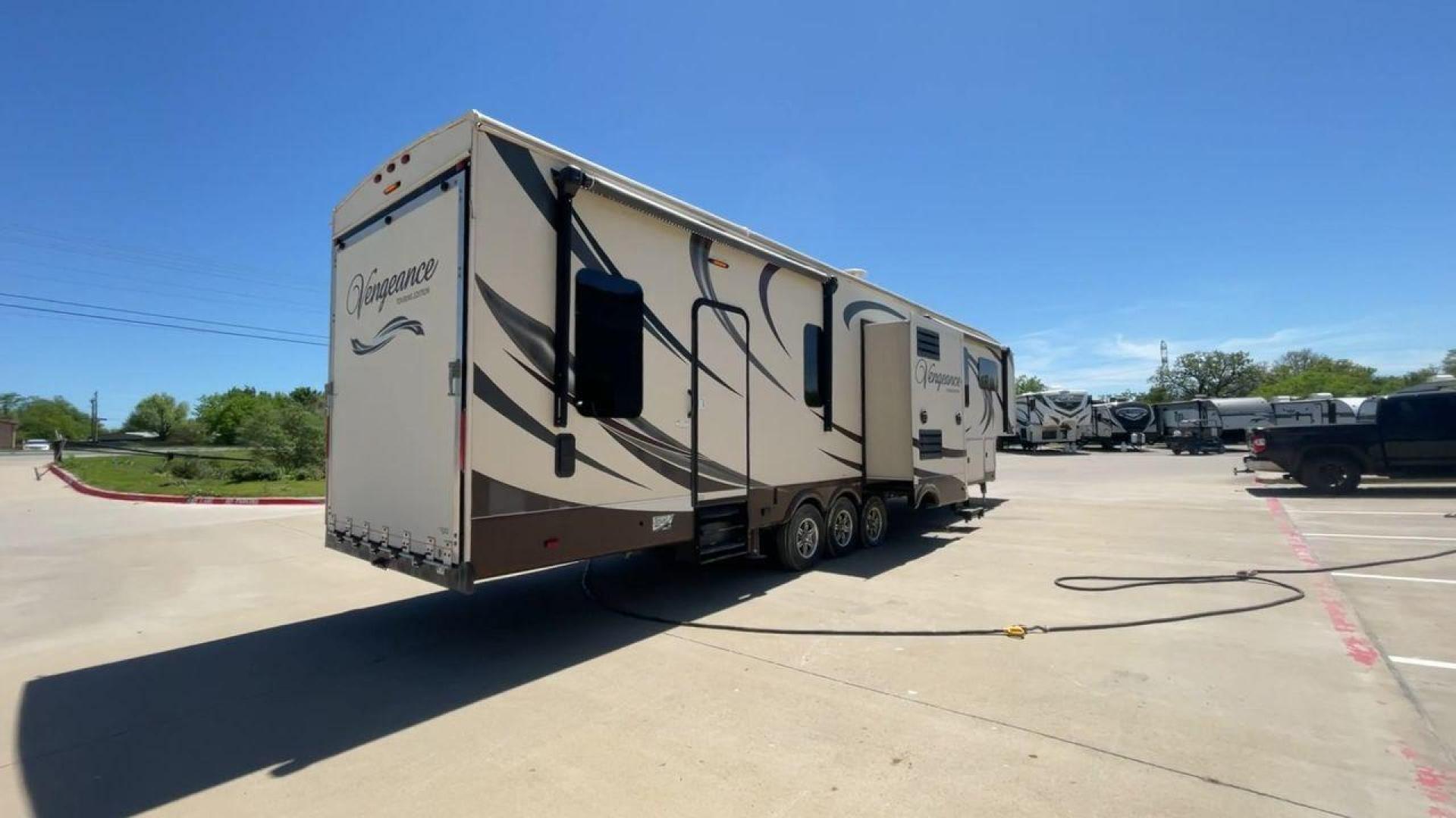 2015 TAN FOREST RIVER VENGEANCE - (4X4FVGR30FR) , Length: 42.83 ft. | Dry Weight: 14,270 lbs. | Gross Weight: 17,500 lbs. | Slides: 3 transmission, located at 4319 N Main St, Cleburne, TX, 76033, (817) 678-5133, 32.385960, -97.391212 - Designed to provide comfort and adventure to your travels, the 2015 Forest River Vengeance 39B12 is a tough and adaptable fifth wheel toy hauler. With a dry weight of 14,270 pounds and a length of a little over 42 feet, this model offers plenty of room for your belongings while still being towable - Photo#1