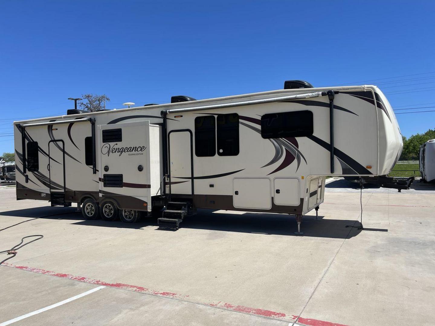 2015 TAN FOREST RIVER VENGEANCE - (4X4FVGR30FR) , Length: 42.83 ft. | Dry Weight: 14,270 lbs. | Gross Weight: 17,500 lbs. | Slides: 3 transmission, located at 4319 N Main St, Cleburne, TX, 76033, (817) 678-5133, 32.385960, -97.391212 - Designed to provide comfort and adventure to your travels, the 2015 Forest River Vengeance 39B12 is a tough and adaptable fifth wheel toy hauler. With a dry weight of 14,270 pounds and a length of a little over 42 feet, this model offers plenty of room for your belongings while still being towable - Photo#22