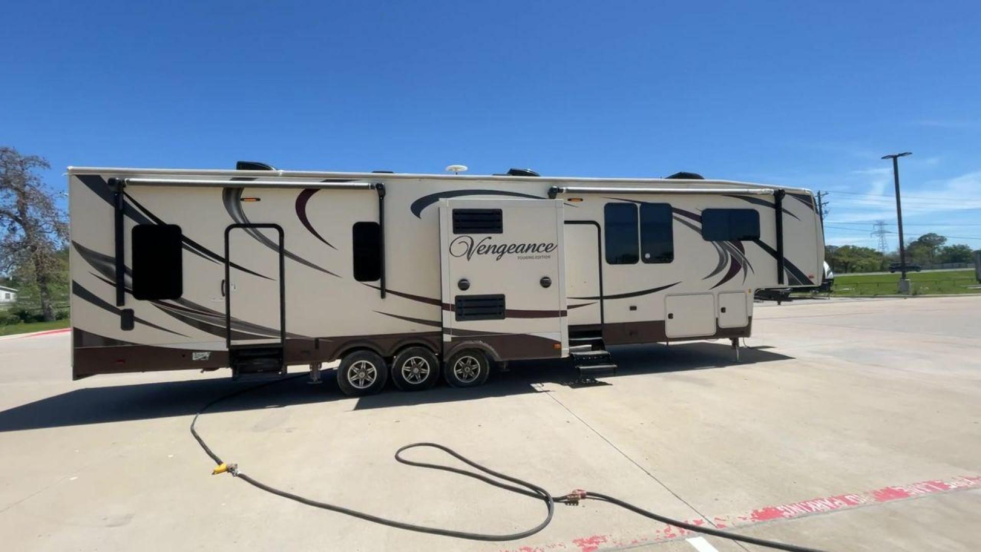 2015 TAN FOREST RIVER VENGEANCE - (4X4FVGR30FR) , Length: 42.83 ft. | Dry Weight: 14,270 lbs. | Gross Weight: 17,500 lbs. | Slides: 3 transmission, located at 4319 N Main St, Cleburne, TX, 76033, (817) 678-5133, 32.385960, -97.391212 - Designed to provide comfort and adventure to your travels, the 2015 Forest River Vengeance 39B12 is a tough and adaptable fifth wheel toy hauler. With a dry weight of 14,270 pounds and a length of a little over 42 feet, this model offers plenty of room for your belongings while still being towable - Photo#2