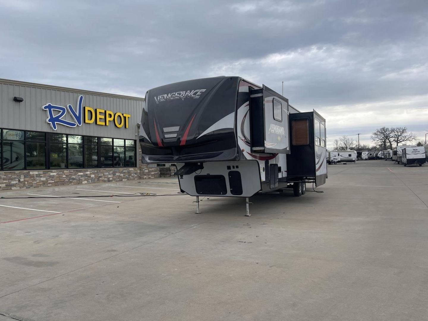 2015 GRAY FOREST RIVER VENGEANCE 320A (4X4FVGH28FY) , Length: 39.25 ft. | Dry Weight: 11,065 lbs. | Gross Weight: 14,697 lbs. | Slides: 3 transmission, located at 4319 N Main St, Cleburne, TX, 76033, (817) 678-5133, 32.385960, -97.391212 - Take advantage of the 2015 Forest River Vengeance 320A toy hauler and unleash your sense of adventure. For individuals who like the freedom to take their favorite toys with them on the road and the excitement of the open road, this sturdy and expertly built RV is ideal. This toy hauler has a dime - Photo#0