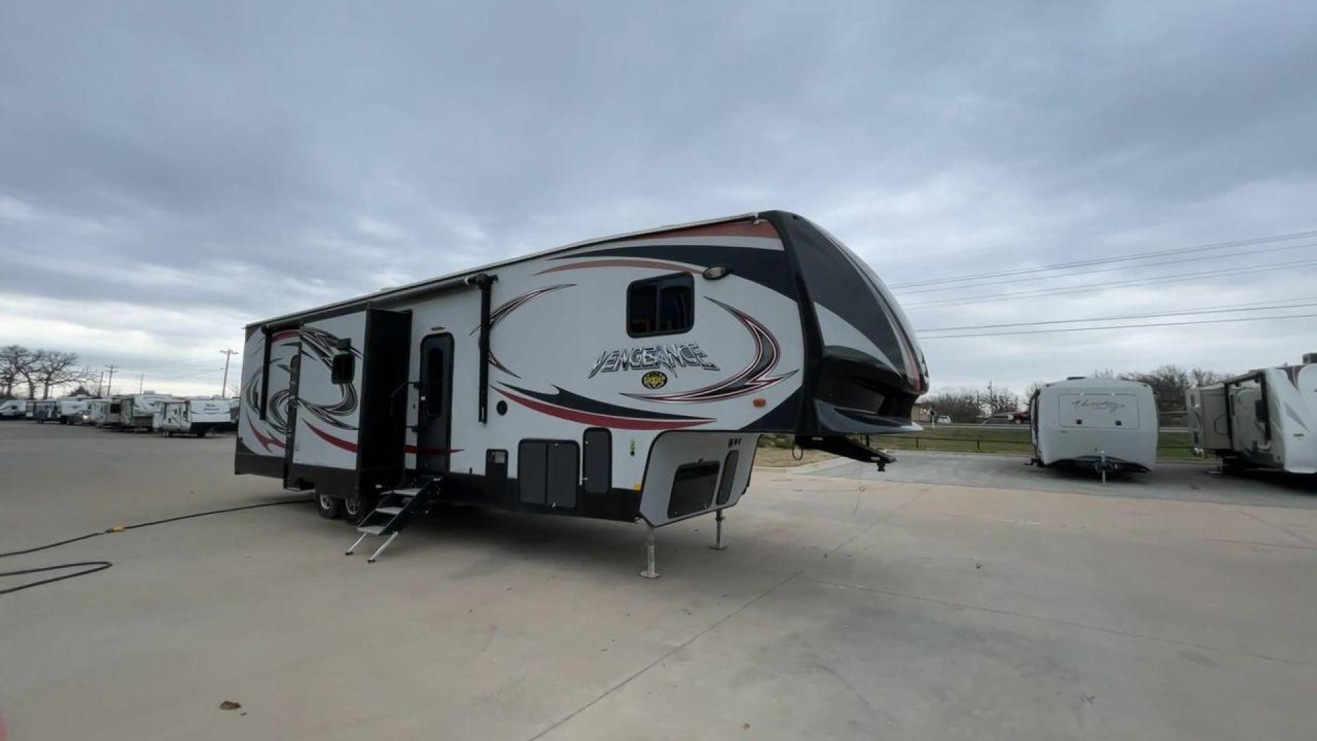 2015 GRAY FOREST RIVER VENGEANCE 320A (4X4FVGH28FY) , Length: 39.25 ft. | Dry Weight: 11,065 lbs. | Gross Weight: 14,697 lbs. | Slides: 3 transmission, located at 4319 N Main St, Cleburne, TX, 76033, (817) 678-5133, 32.385960, -97.391212 - Take advantage of the 2015 Forest River Vengeance 320A toy hauler and unleash your sense of adventure. For individuals who like the freedom to take their favorite toys with them on the road and the excitement of the open road, this sturdy and expertly built RV is ideal. This toy hauler has a dime - Photo#3