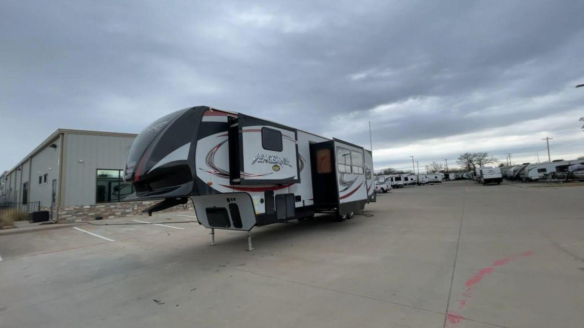 2015 GRAY FOREST RIVER VENGEANCE 320A (4X4FVGH28FY) , Length: 39.25 ft. | Dry Weight: 11,065 lbs. | Gross Weight: 14,697 lbs. | Slides: 3 transmission, located at 4319 N Main St, Cleburne, TX, 76033, (817) 678-5133, 32.385960, -97.391212 - Take advantage of the 2015 Forest River Vengeance 320A toy hauler and unleash your sense of adventure. For individuals who like the freedom to take their favorite toys with them on the road and the excitement of the open road, this sturdy and expertly built RV is ideal. This toy hauler has a dime - Photo#5