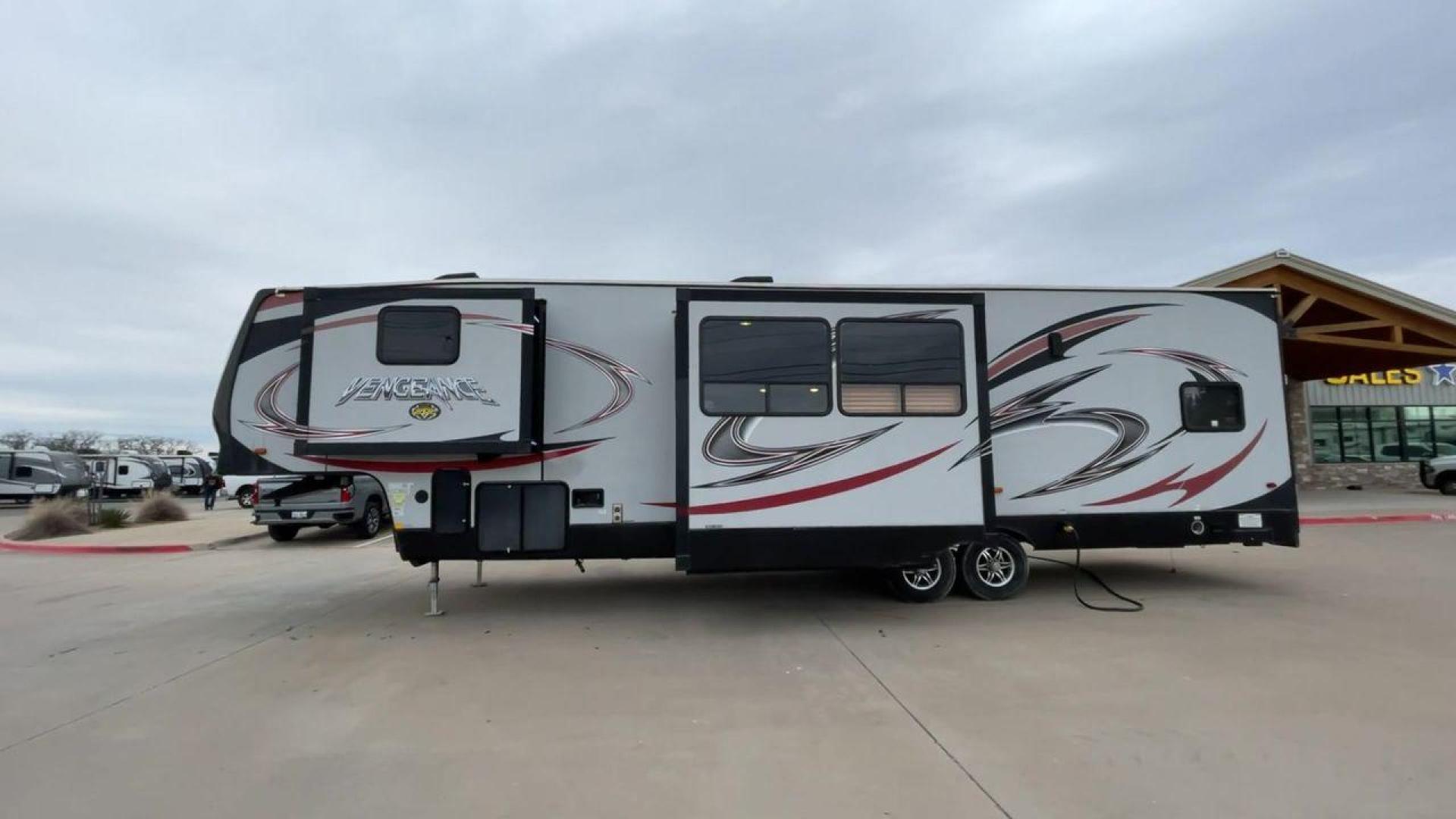 2015 GRAY FOREST RIVER VENGEANCE 320A (4X4FVGH28FY) , Length: 39.25 ft. | Dry Weight: 11,065 lbs. | Gross Weight: 14,697 lbs. | Slides: 3 transmission, located at 4319 N Main St, Cleburne, TX, 76033, (817) 678-5133, 32.385960, -97.391212 - Take advantage of the 2015 Forest River Vengeance 320A toy hauler and unleash your sense of adventure. For individuals who like the freedom to take their favorite toys with them on the road and the excitement of the open road, this sturdy and expertly built RV is ideal. This toy hauler has a dime - Photo#6