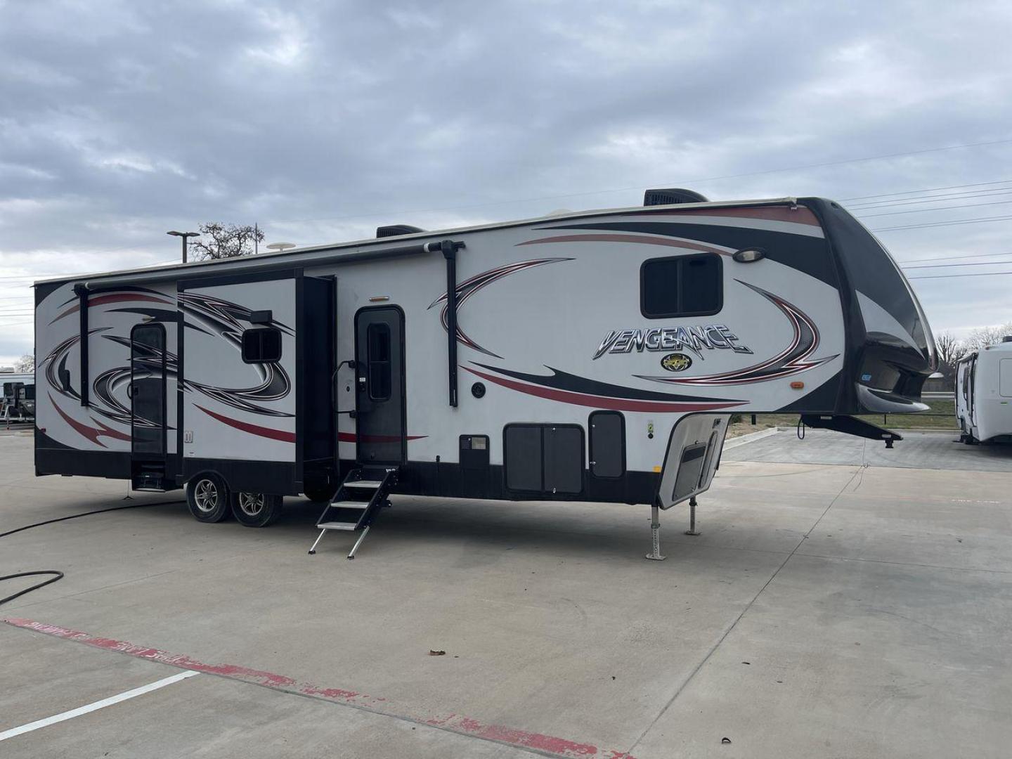 2015 GRAY FOREST RIVER VENGEANCE 320A (4X4FVGH28FY) , Length: 39.25 ft. | Dry Weight: 11,065 lbs. | Gross Weight: 14,697 lbs. | Slides: 3 transmission, located at 4319 N Main St, Cleburne, TX, 76033, (817) 678-5133, 32.385960, -97.391212 - Take advantage of the 2015 Forest River Vengeance 320A toy hauler and unleash your sense of adventure. For individuals who like the freedom to take their favorite toys with them on the road and the excitement of the open road, this sturdy and expertly built RV is ideal. This toy hauler has a dime - Photo#23