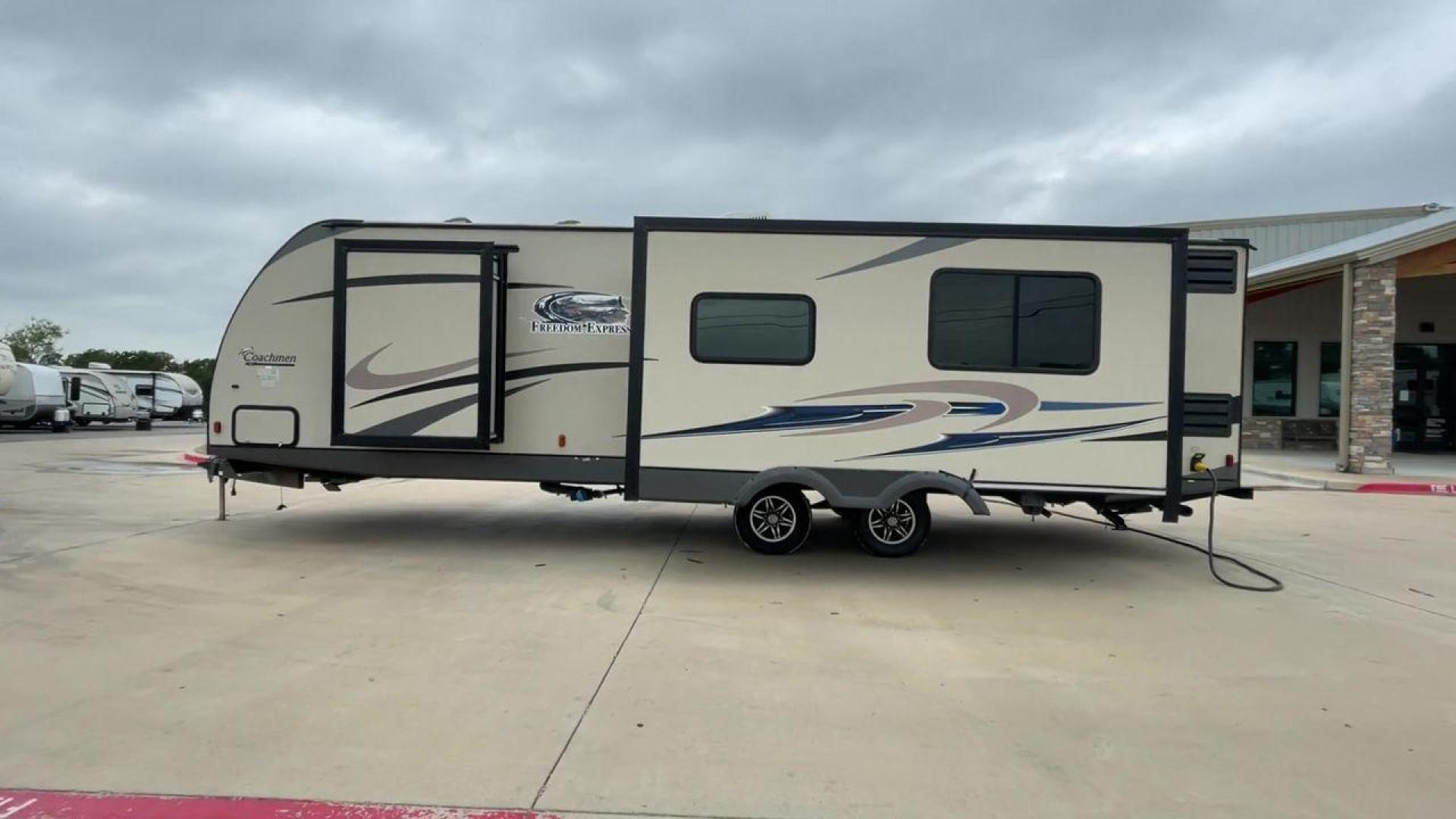 2015 TAN FREEDOM EXPRESS 305RKDS (5ZT2FEWB1FA) , Length: 34.5 ft. | Dry Weight: 6,199 lbs | Gross Weight: 9,500 lbs. | Slides: 2 transmission, located at 4319 N Main St, Cleburne, TX, 76033, (817) 678-5133, 32.385960, -97.391212 - The 2015 Freedom Express 305RKDS is a travel trailer designed to deliver an exceptional camping experience, combining freedom and comfort in every detail. It boasts a rear kitchen layout, providing a unique and functional living space. The rear kitchen is equipped with high-end appliances, ample cou - Photo#1