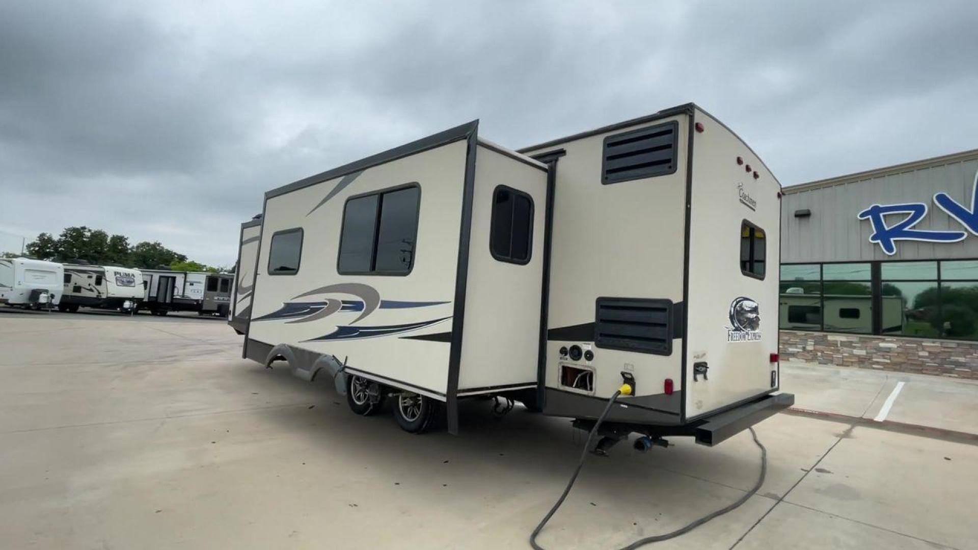 2015 TAN FREEDOM EXPRESS 305RKDS (5ZT2FEWB1FA) , Length: 34.5 ft. | Dry Weight: 6,199 lbs | Gross Weight: 9,500 lbs. | Slides: 2 transmission, located at 4319 N Main St, Cleburne, TX, 76033, (817) 678-5133, 32.385960, -97.391212 - The 2015 Freedom Express 305RKDS is a travel trailer designed to deliver an exceptional camping experience, combining freedom and comfort in every detail. It boasts a rear kitchen layout, providing a unique and functional living space. The rear kitchen is equipped with high-end appliances, ample cou - Photo#2