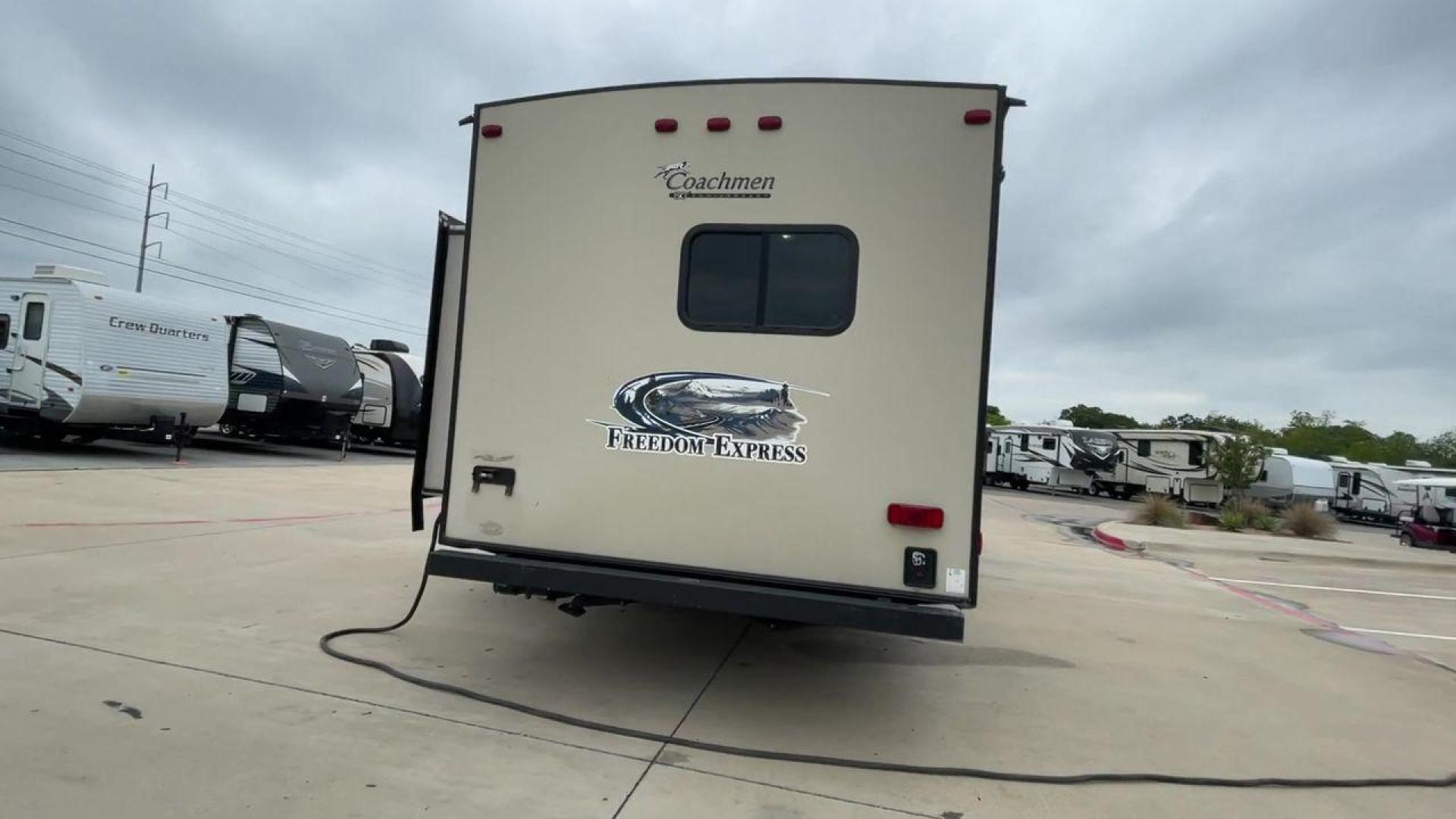 2015 TAN FREEDOM EXPRESS 305RKDS (5ZT2FEWB1FA) , Length: 34.5 ft. | Dry Weight: 6,199 lbs | Gross Weight: 9,500 lbs. | Slides: 2 transmission, located at 4319 N Main St, Cleburne, TX, 76033, (817) 678-5133, 32.385960, -97.391212 - The 2015 Freedom Express 305RKDS is a travel trailer designed to deliver an exceptional camping experience, combining freedom and comfort in every detail. It boasts a rear kitchen layout, providing a unique and functional living space. The rear kitchen is equipped with high-end appliances, ample cou - Photo#3