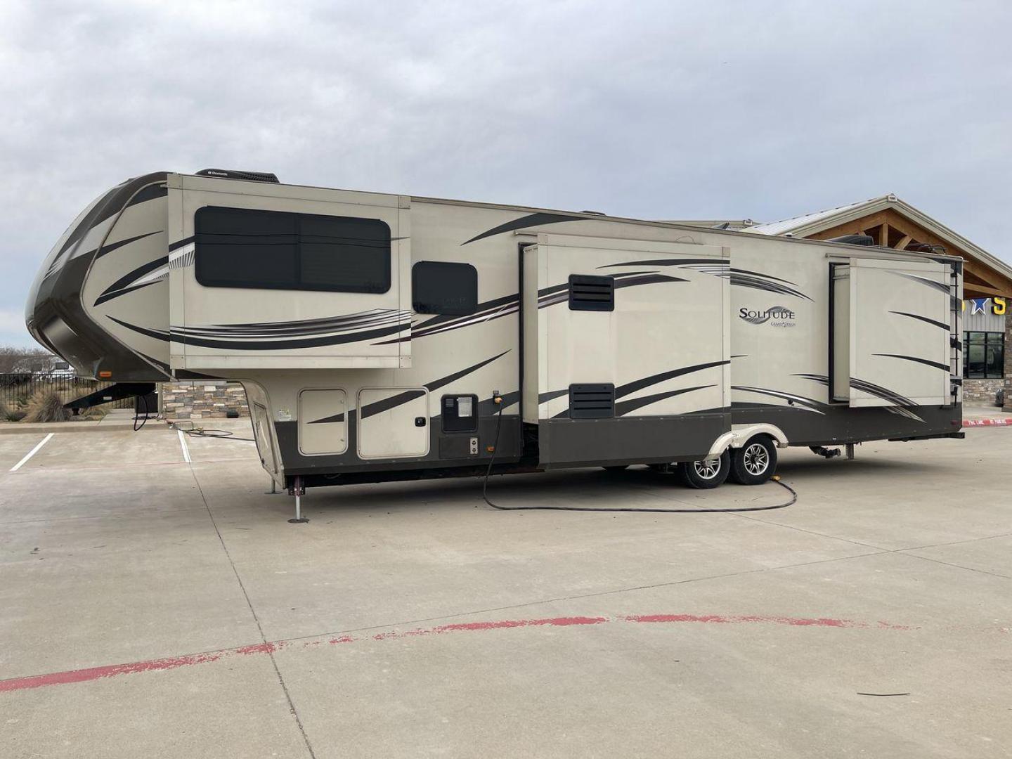 2015 BEIGE GRAND DESIGN SOLITUDE 379FL (573FS4325F1) , Length: 42.5 ft. | Dry Weight: 13,800 lbs. | Gross Weight: 16,000 lbs. | Slides: 5 transmission, located at 4319 N Main St, Cleburne, TX, 76033, (817) 678-5133, 32.385960, -97.391212 - This 2015 GRSL Solitude 379 fifth wheel measures just over 42' in length. It is a dual axle and aluminum wheel setup with a GCWR of 16,000 lbs and a carrying capacity of 2,200 lbs. With five slides, this fifth wheel is spacious and comfortable! The Solitude's exterior is made from fiberglass, finish - Photo#21