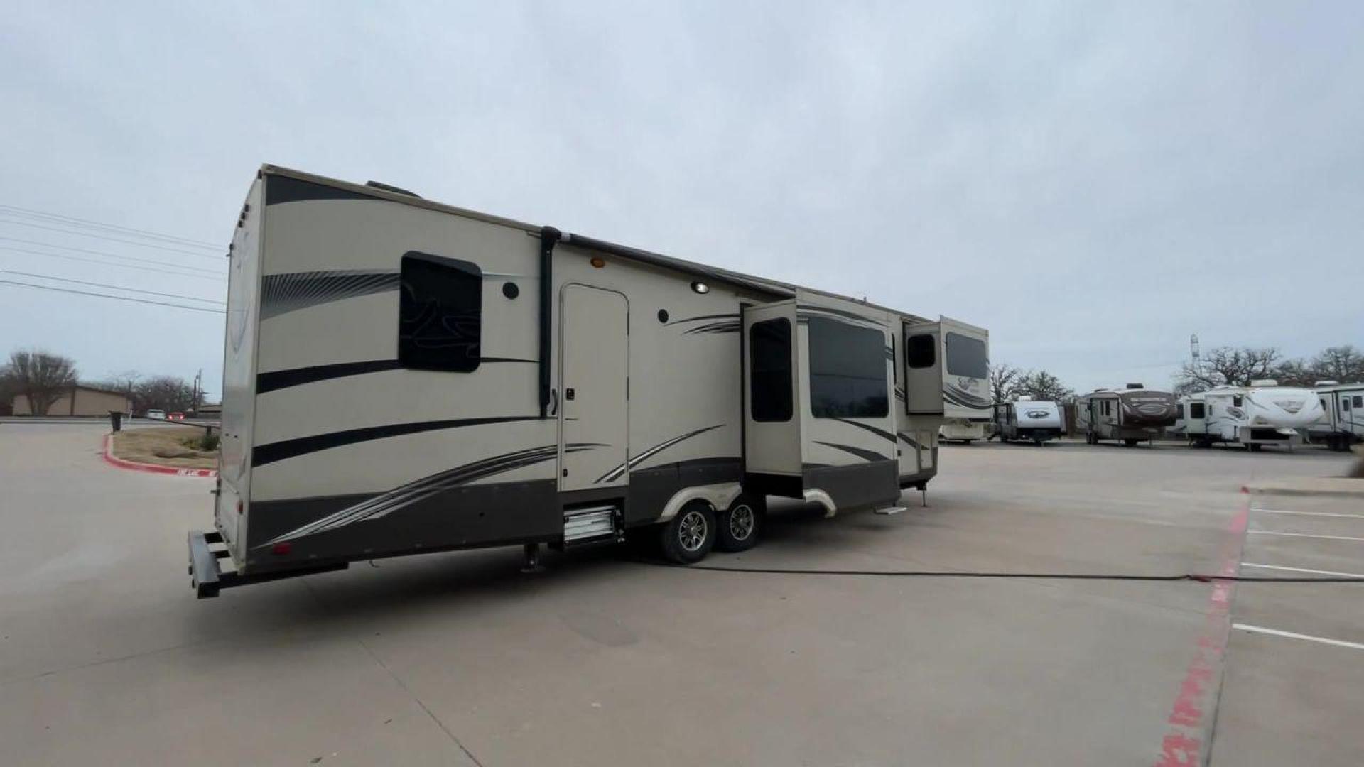 2015 BEIGE GRAND DESIGN SOLITUDE 379FL (573FS4325F1) , Length: 42.5 ft. | Dry Weight: 13,800 lbs. | Gross Weight: 16,000 lbs. | Slides: 5 transmission, located at 4319 N Main St, Cleburne, TX, 76033, (817) 678-5133, 32.385960, -97.391212 - This 2015 GRSL Solitude 379 fifth wheel measures just over 42' in length. It is a dual axle and aluminum wheel setup with a GCWR of 16,000 lbs and a carrying capacity of 2,200 lbs. With five slides, this fifth wheel is spacious and comfortable! The Solitude's exterior is made from fiberglass, finish - Photo#1