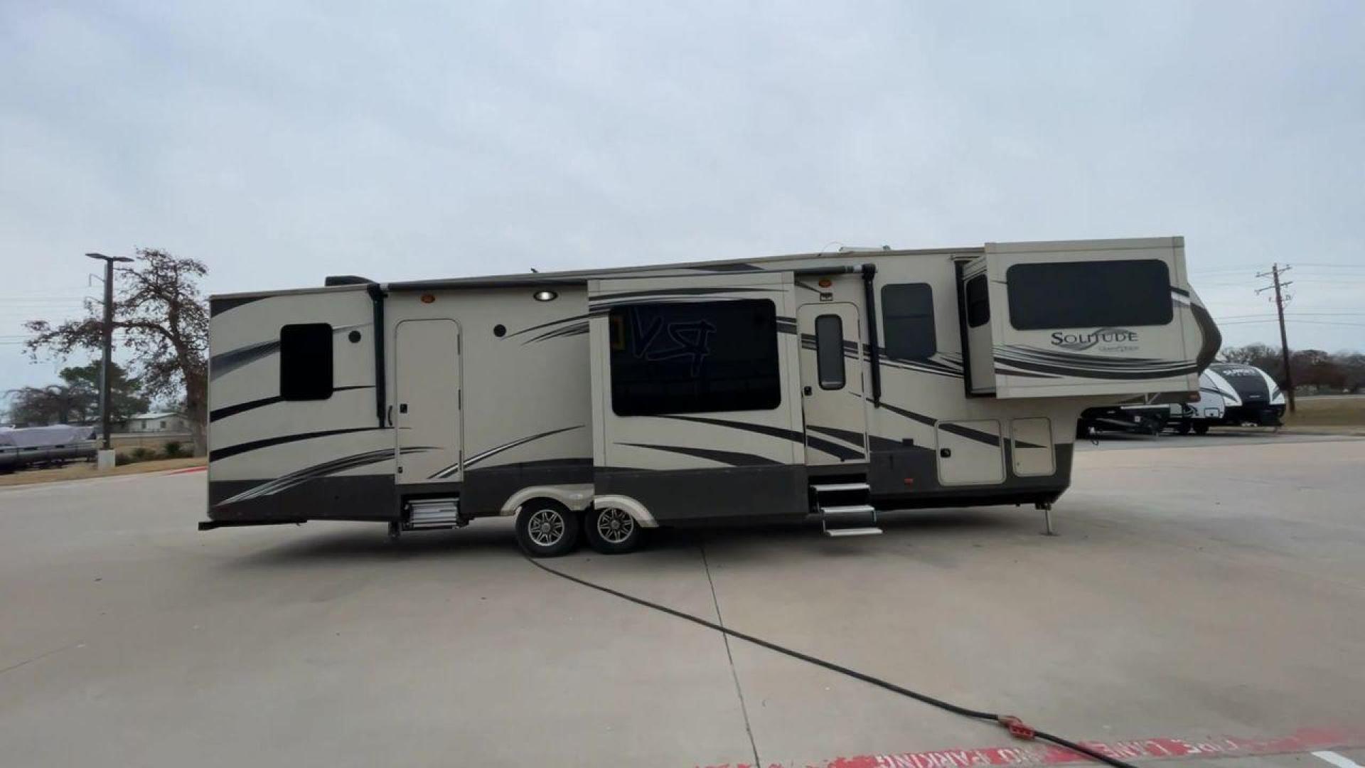 2015 BEIGE GRAND DESIGN SOLITUDE 379FL (573FS4325F1) , Length: 42.5 ft. | Dry Weight: 13,800 lbs. | Gross Weight: 16,000 lbs. | Slides: 5 transmission, located at 4319 N Main St, Cleburne, TX, 76033, (817) 678-5133, 32.385960, -97.391212 - This 2015 GRSL Solitude 379 fifth wheel measures just over 42' in length. It is a dual axle and aluminum wheel setup with a GCWR of 16,000 lbs and a carrying capacity of 2,200 lbs. With five slides, this fifth wheel is spacious and comfortable! The Solitude's exterior is made from fiberglass, finish - Photo#2