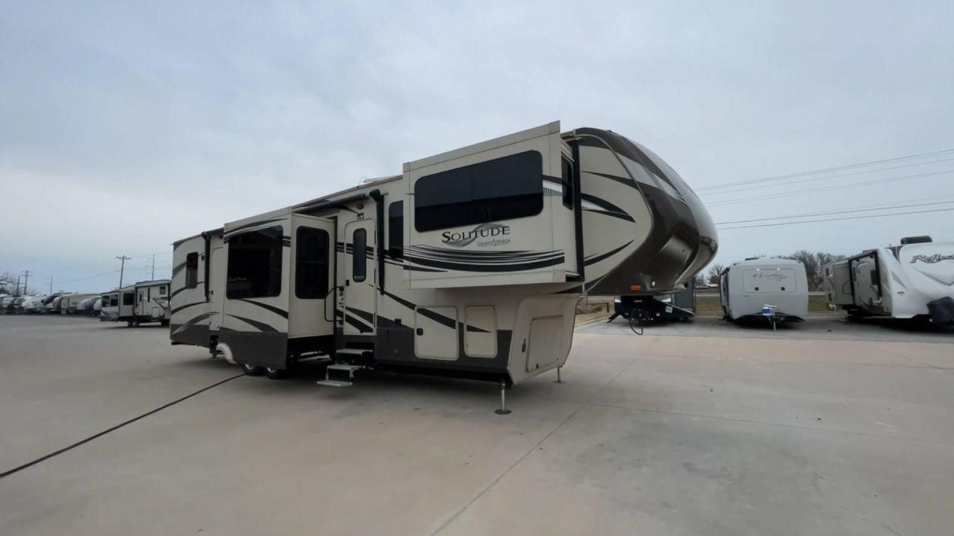 2015 BEIGE GRAND DESIGN SOLITUDE 379FL (573FS4325F1) , Length: 42.5 ft. | Dry Weight: 13,800 lbs. | Gross Weight: 16,000 lbs. | Slides: 5 transmission, located at 4319 N Main St, Cleburne, TX, 76033, (817) 678-5133, 32.385960, -97.391212 - This 2015 GRSL Solitude 379 fifth wheel measures just over 42' in length. It is a dual axle and aluminum wheel setup with a GCWR of 16,000 lbs and a carrying capacity of 2,200 lbs. With five slides, this fifth wheel is spacious and comfortable! The Solitude's exterior is made from fiberglass, finish - Photo#3