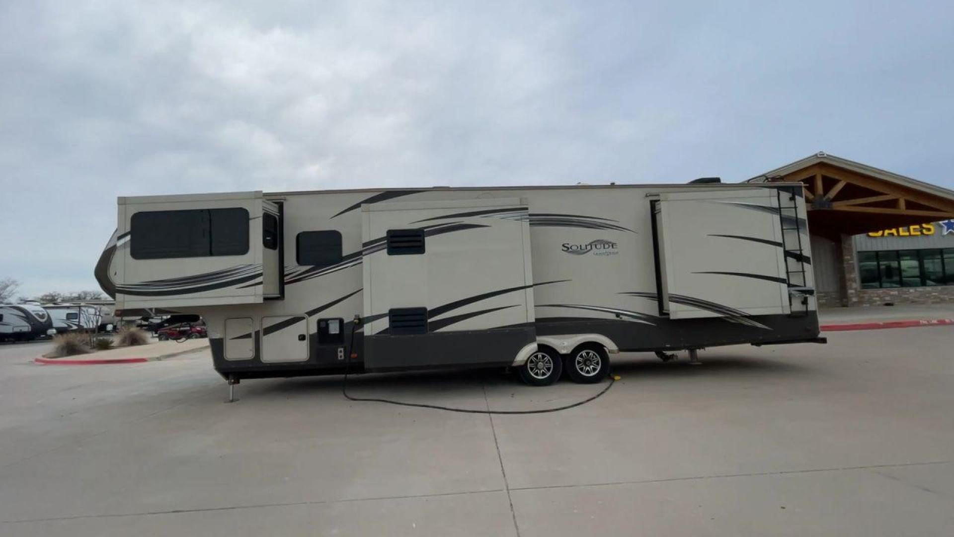 2015 BEIGE GRAND DESIGN SOLITUDE 379FL (573FS4325F1) , Length: 42.5 ft. | Dry Weight: 13,800 lbs. | Gross Weight: 16,000 lbs. | Slides: 5 transmission, located at 4319 N Main St, Cleburne, TX, 76033, (817) 678-5133, 32.385960, -97.391212 - This 2015 GRSL Solitude 379 fifth wheel measures just over 42' in length. It is a dual axle and aluminum wheel setup with a GCWR of 16,000 lbs and a carrying capacity of 2,200 lbs. With five slides, this fifth wheel is spacious and comfortable! The Solitude's exterior is made from fiberglass, finish - Photo#6