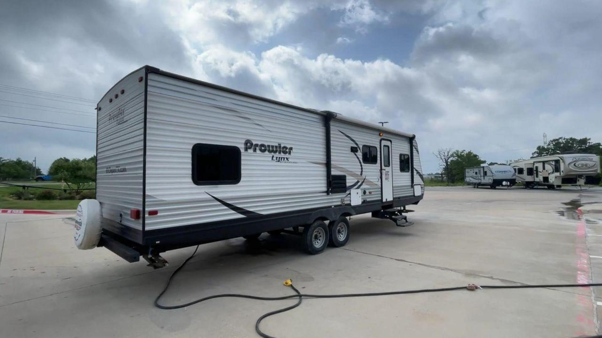 2015 HEARTLAND PROWLER 30LX (5SFPB3328FE) , Length: 33.9 ft | Dry Weight: 6,720 lbs | Gross Weight: 9,000 lbs | Slides: 1 transmission, located at 4319 N Main St, Cleburne, TX, 76033, (817) 678-5133, 32.385960, -97.391212 - Experience both comfort and adventure with the 2015 Heartland Prowler 30LX travel trailer. This trailer, measuring 33.9 feet long and having a single slide, provides plenty of space for your family and friends to enjoy the great outdoors. With a dry weight of 6,720 pounds and a gross weight of 9,000 - Photo#1