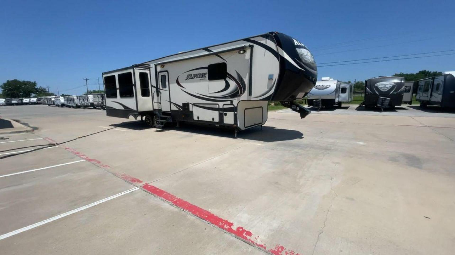 2015 WHITE KEYSTONE ALPINE 3535RE (4YDF35320FE) , Length: 39.08 ft. | Dry Weight: 12,416 lbs. | Gross Weight: 15,500 lbs. | Slides: 4 transmission, located at 4319 N Main St, Cleburne, TX, 76033, (817) 678-5133, 32.385960, -97.391212 - Improve your RV experience with the 2015 Keystone Alpine 3535RE, a high-end fifth wheel that embodies ease and style. This model, which is an impressive 39.08 feet long, was carefully made for discerning travelers who want a perfect mix of style and usefulness. Because it is made of an aluminum body - Photo#3