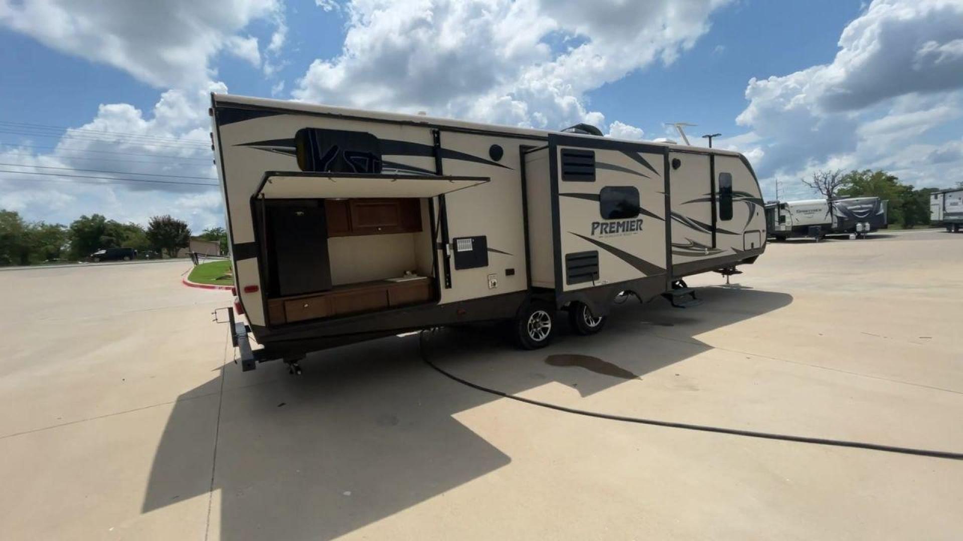 2015 TAN KEYSTONE PREMIER 34BHPR (4YDT34B25FD) , Length: 37 ft. | Dry Weight: 7,076 lbs. | Gross Weight: 8,800 lbs. | Slides: 3 transmission, located at 4319 N Main St, Cleburne, TX, 76033, (817) 678-5133, 32.385960, -97.391212 - Take a trip with more family members and friends in this remarkably spacious 2015 Keystone Premier 34BHPR! This travel trailer measures exactly 37 ft. in length and 10.92 ft. in height. It has a dry weight of 7,076 lbs. and a GVWR of 8,800 lbs. It highlights a rear bunk and an outside kitchen, ma - Photo#1