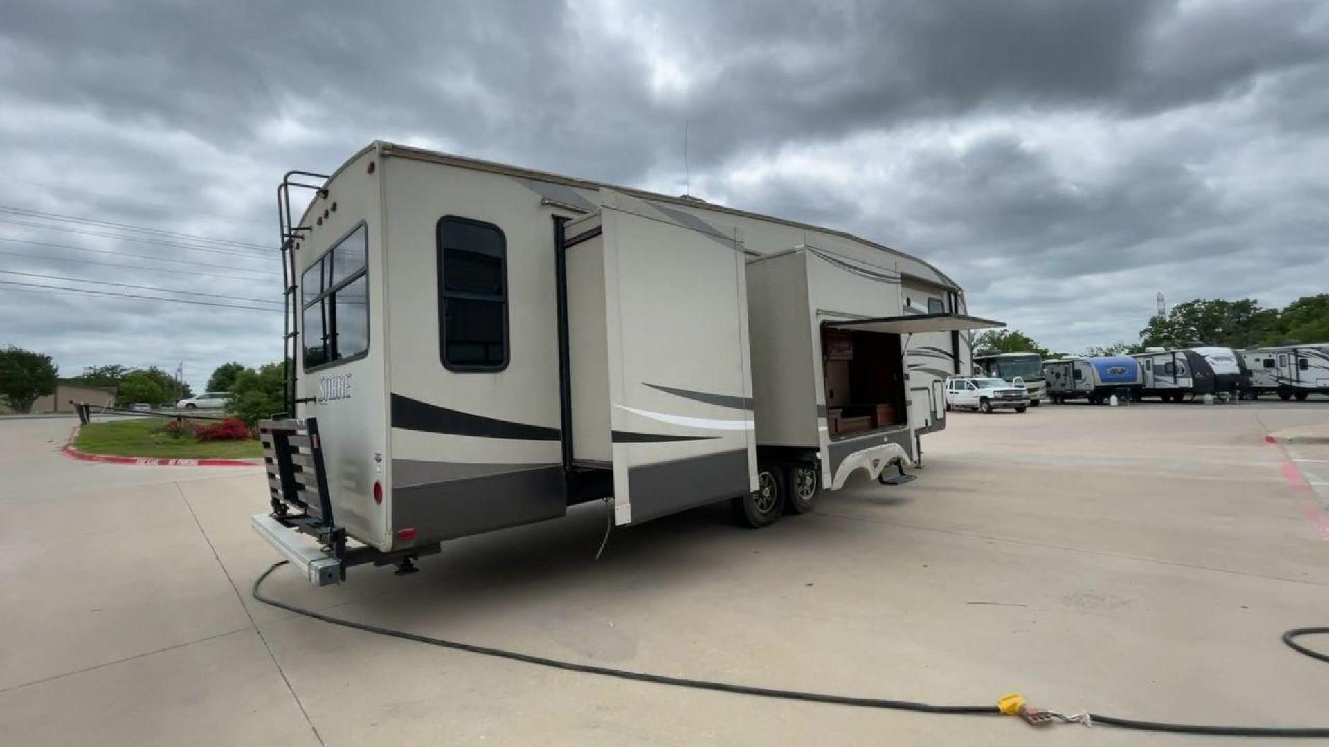 2015 TAN PALOMINO SABRE 34RDKS (4X4FSRK2XF3) , Length: 38.92 ft. | Dry Weight: 11,081 lbs. | Gross Weight: 13,950 lbs. | Slides: 4 transmission, located at 4319 N Main St, Cleburne, TX, 76033, (817) 678-5133, 32.385960, -97.391212 - This 2015 Sabre Fifth Wheel measures at just under 39 feet with a dry weight of 11,081 lbs. It has a GVWR of 13,950 lbs and a hitch weight of 2,205 lbs. This unit has a heater rated at 35,000 BTUs and a cooler rated at 13,500 BTUs meaning the temperature is always in your control. This model has a b - Photo#1