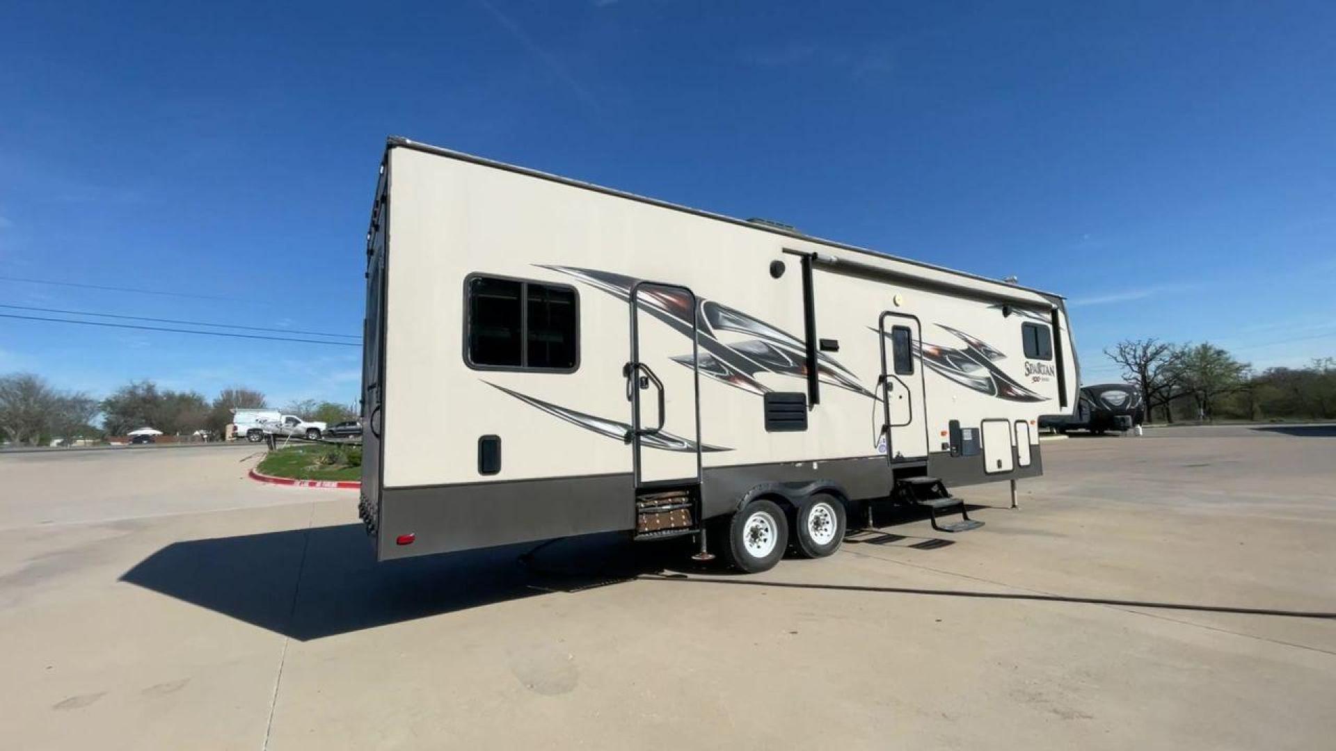 2015 WHITE SPARTAN 3210 (5ZT3STXBXFG) , located at 4319 N Main St, Cleburne, TX, 76033, (817) 678-5133, 32.385960, -97.391212 - Here are additional factors highlighting why owning this RV is a superb choice. (1) The 2015 Spartan 3210 Toy Hauler has Aluminum-framed construction with vacuum-bonded laminated sidewalls (2) It features Electric patio awning, Pass-through storage compartments and Spare tire with lockable compa - Photo#1