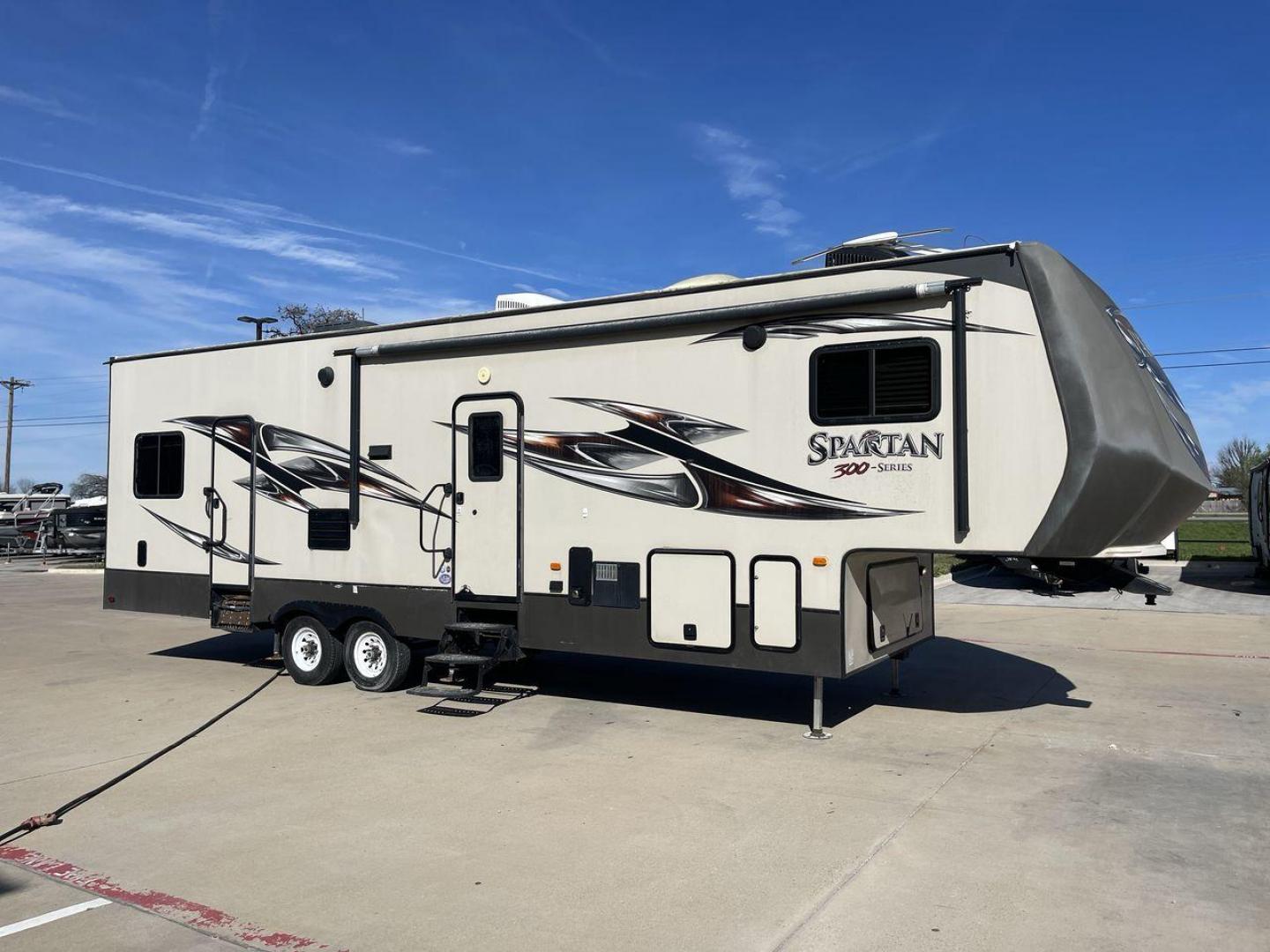 2015 WHITE SPARTAN 3210 (5ZT3STXBXFG) , located at 4319 N Main St, Cleburne, TX, 76033, (817) 678-5133, 32.385960, -97.391212 - Here are additional factors highlighting why owning this RV is a superb choice. (1) The 2015 Spartan 3210 Toy Hauler has Aluminum-framed construction with vacuum-bonded laminated sidewalls (2) It features Electric patio awning, Pass-through storage compartments and Spare tire with lockable compa - Photo#23