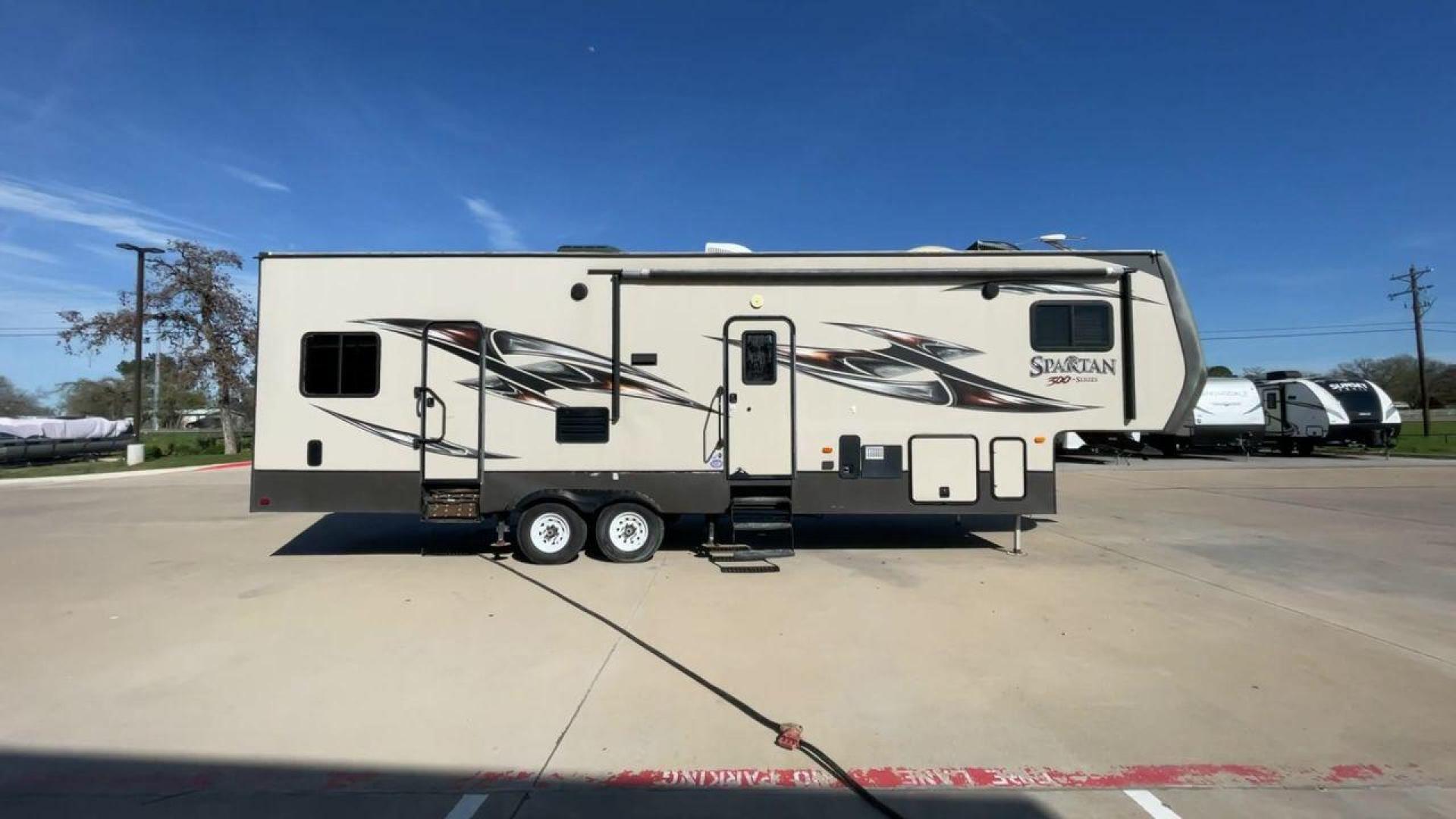 2015 WHITE SPARTAN 3210 (5ZT3STXBXFG) , located at 4319 N Main St, Cleburne, TX, 76033, (817) 678-5133, 32.385960, -97.391212 - Here are additional factors highlighting why owning this RV is a superb choice. (1) The 2015 Spartan 3210 Toy Hauler has Aluminum-framed construction with vacuum-bonded laminated sidewalls (2) It features Electric patio awning, Pass-through storage compartments and Spare tire with lockable compa - Photo#2