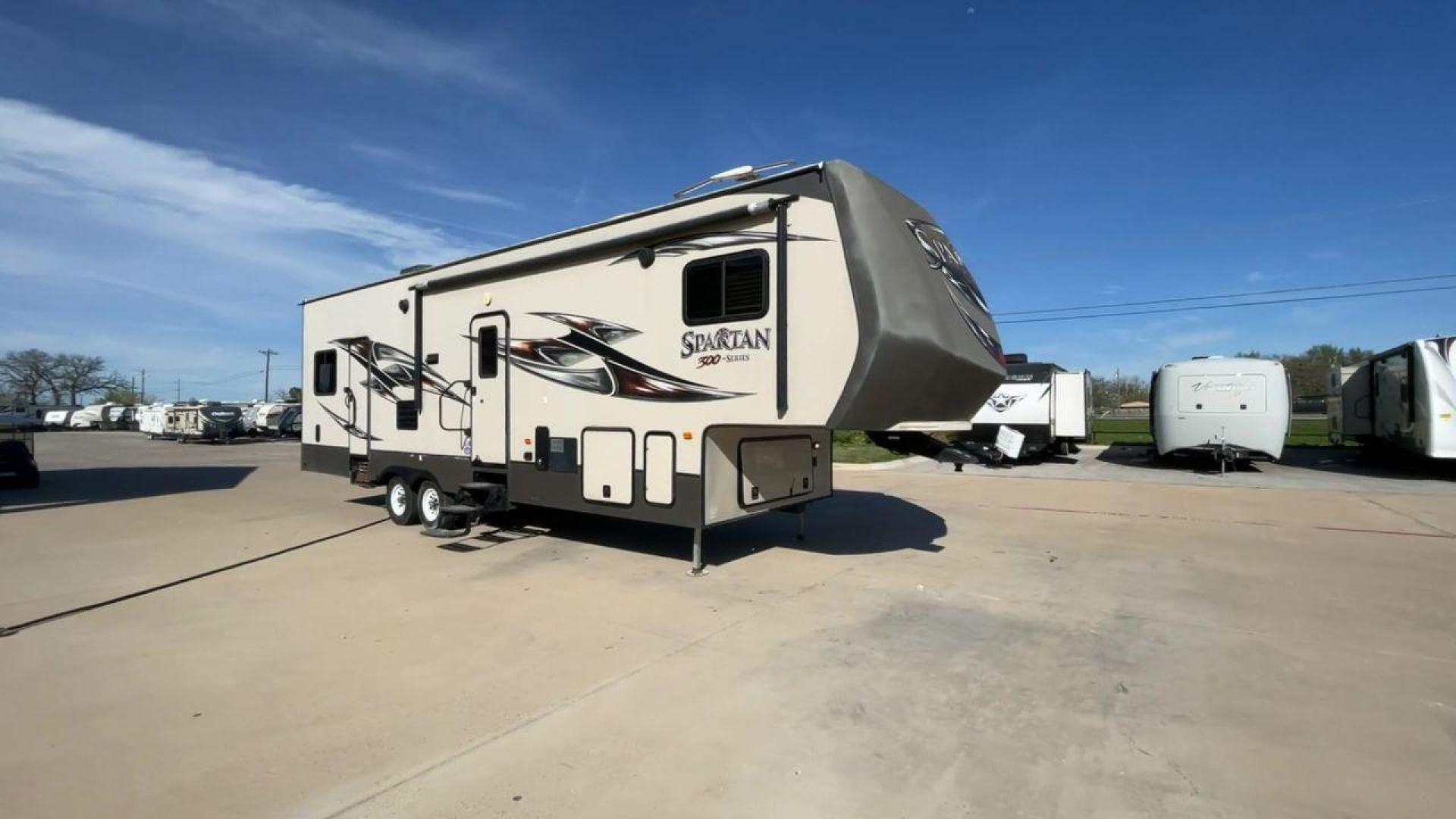 2015 WHITE SPARTAN 3210 (5ZT3STXBXFG) , located at 4319 N Main St, Cleburne, TX, 76033, (817) 678-5133, 32.385960, -97.391212 - Here are additional factors highlighting why owning this RV is a superb choice. (1) The 2015 Spartan 3210 Toy Hauler has Aluminum-framed construction with vacuum-bonded laminated sidewalls (2) It features Electric patio awning, Pass-through storage compartments and Spare tire with lockable compa - Photo#3