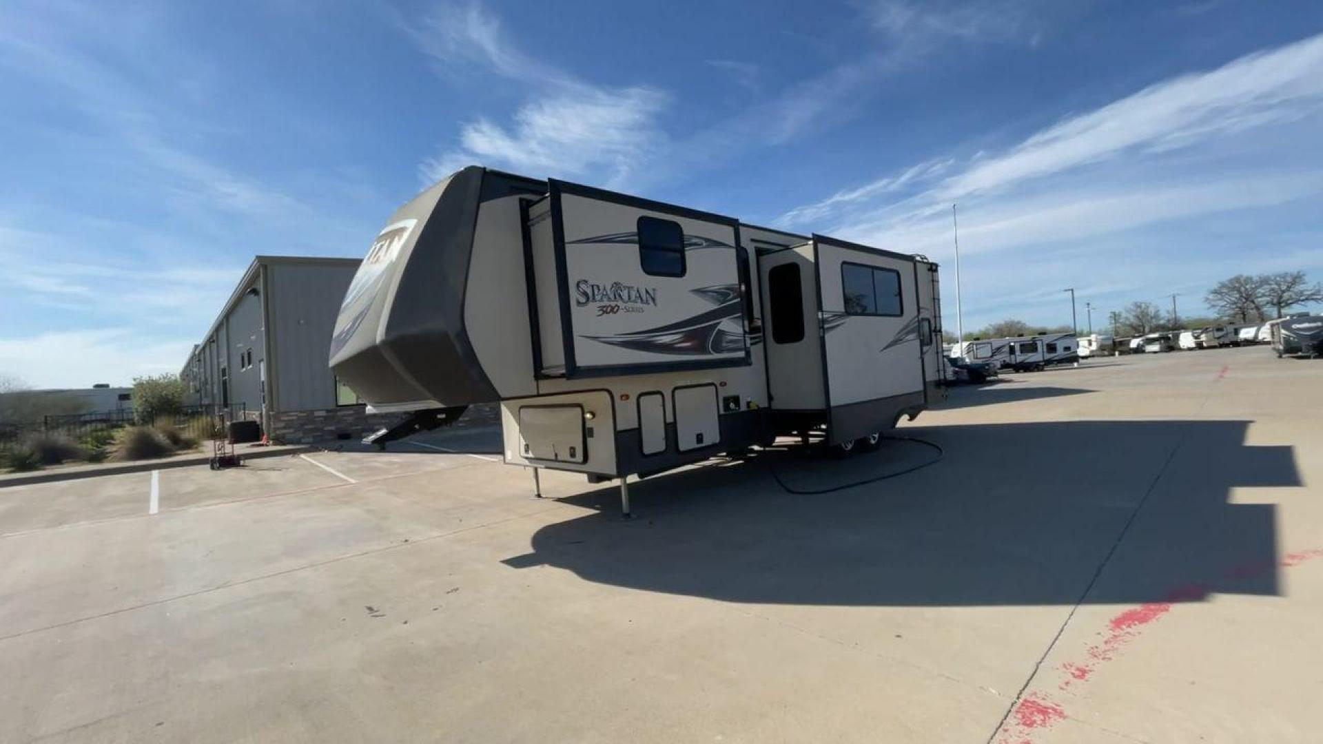 2015 WHITE SPARTAN 3210 (5ZT3STXBXFG) , located at 4319 N Main St, Cleburne, TX, 76033, (817) 678-5133, 32.385960, -97.391212 - Here are additional factors highlighting why owning this RV is a superb choice. (1) The 2015 Spartan 3210 Toy Hauler has Aluminum-framed construction with vacuum-bonded laminated sidewalls (2) It features Electric patio awning, Pass-through storage compartments and Spare tire with lockable compa - Photo#5