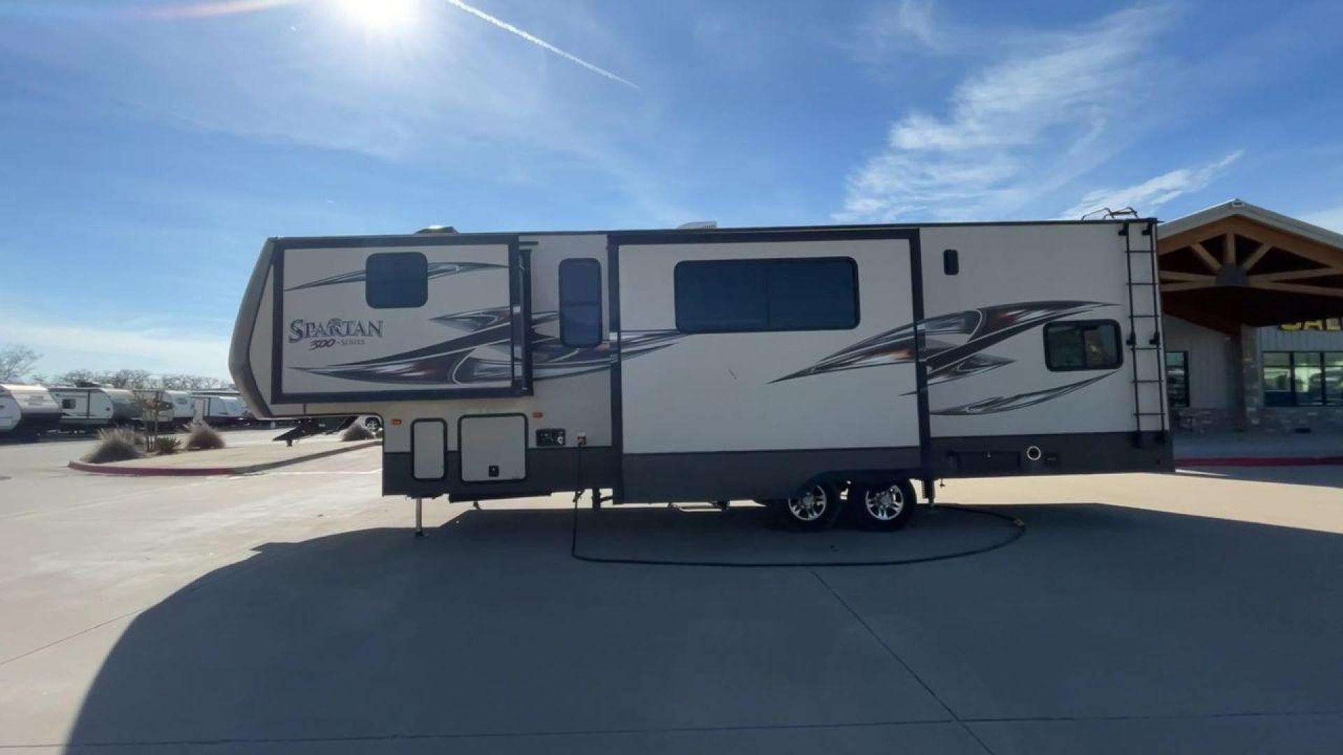 2015 WHITE SPARTAN 3210 (5ZT3STXBXFG) , located at 4319 N Main St, Cleburne, TX, 76033, (817) 678-5133, 32.385960, -97.391212 - Here are additional factors highlighting why owning this RV is a superb choice. (1) The 2015 Spartan 3210 Toy Hauler has Aluminum-framed construction with vacuum-bonded laminated sidewalls (2) It features Electric patio awning, Pass-through storage compartments and Spare tire with lockable compa - Photo#6