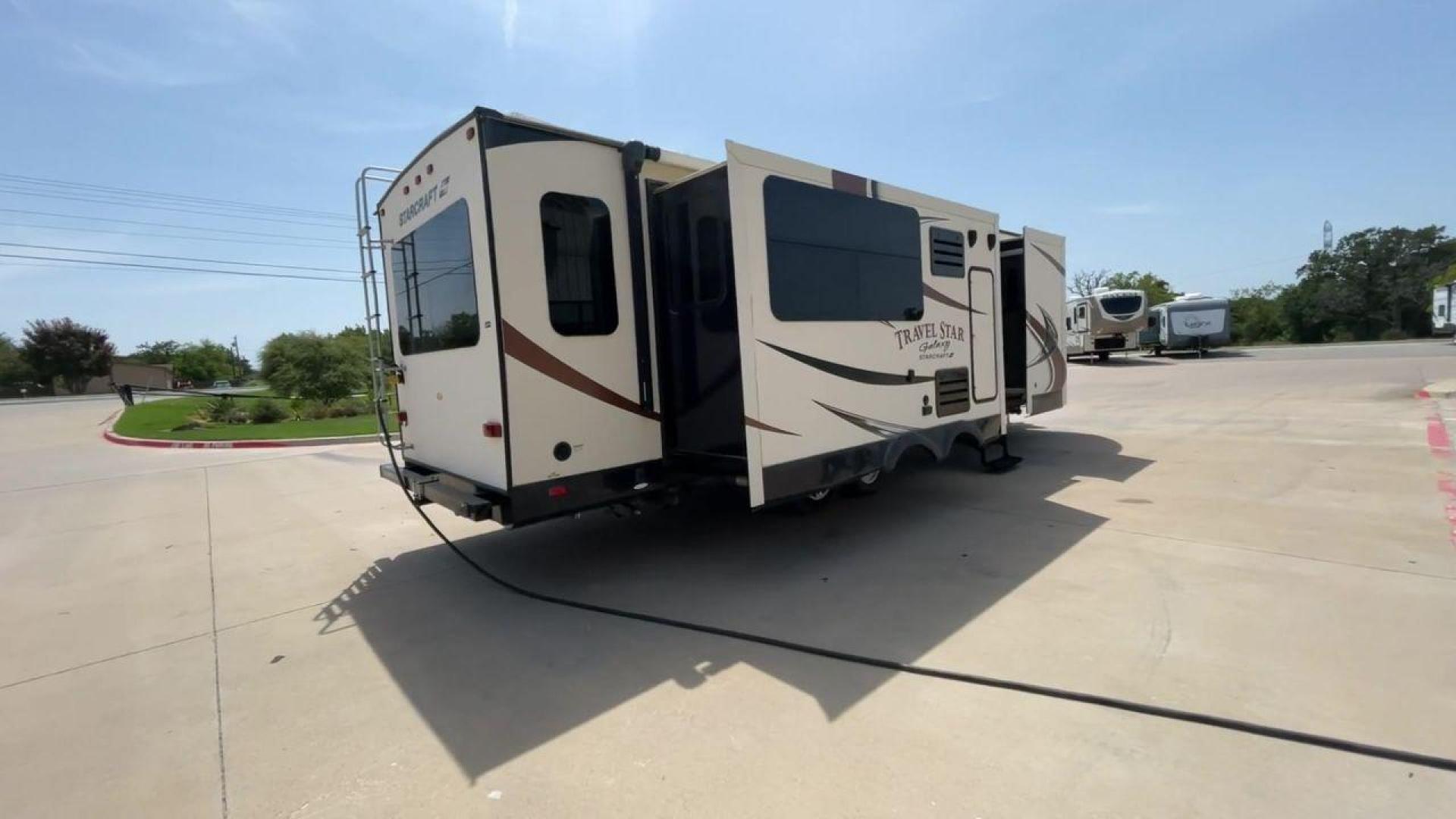 2015 TAN STARCRAFT TRAVEL STAR 294RESA (1SABS0BR5F2) , Length: 34 ft. | Dry Weight: 7,230 lbs. | Gross Weight: 9,250 lbs. | Slides: 3 transmission, located at 4319 N Main St, Cleburne, TX, 76033, (817) 678-5133, 32.385960, -97.391212 - This 2015 Travel Star 294RESA is a dual-axle steel wheel setup measuring 34 ft. in length and 11.38 ft. in height. It has a dry weight of 7,230 lbs. and a GVWR of 9,250 lbs. It also has a hitch weight of 865 lbs. This travel trailer includes three slides as well as one awning. The interior features - Photo#1