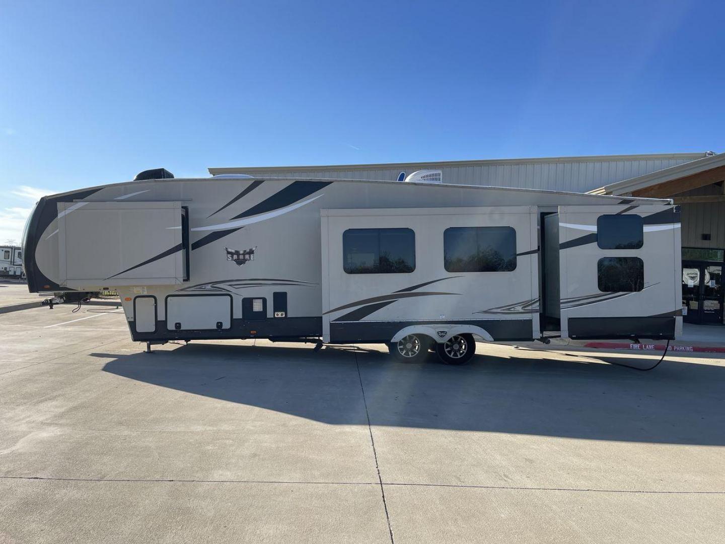 2016 BROWN FOREST RIVER SABRE 360QB (4X4FSRM26G3) , Length: 41.83 ft. | Dry Weight: 12,264 lbs. | Gross Weight: 15,500 lbs. | Slides: 4 transmission, located at 4319 N Main St, Cleburne, TX, 76033, (817) 678-5133, 32.385960, -97.391212 - The 2016 Forest River Sabre 360QB fifth wheel features a cream-colored finish accented with bold, modern graphics, giving it a contemporary and appealing look. The aerodynamic front cap is designed for improved towing performance and aesthetics. This unit is equipped with four large slideouts that s - Photo#24